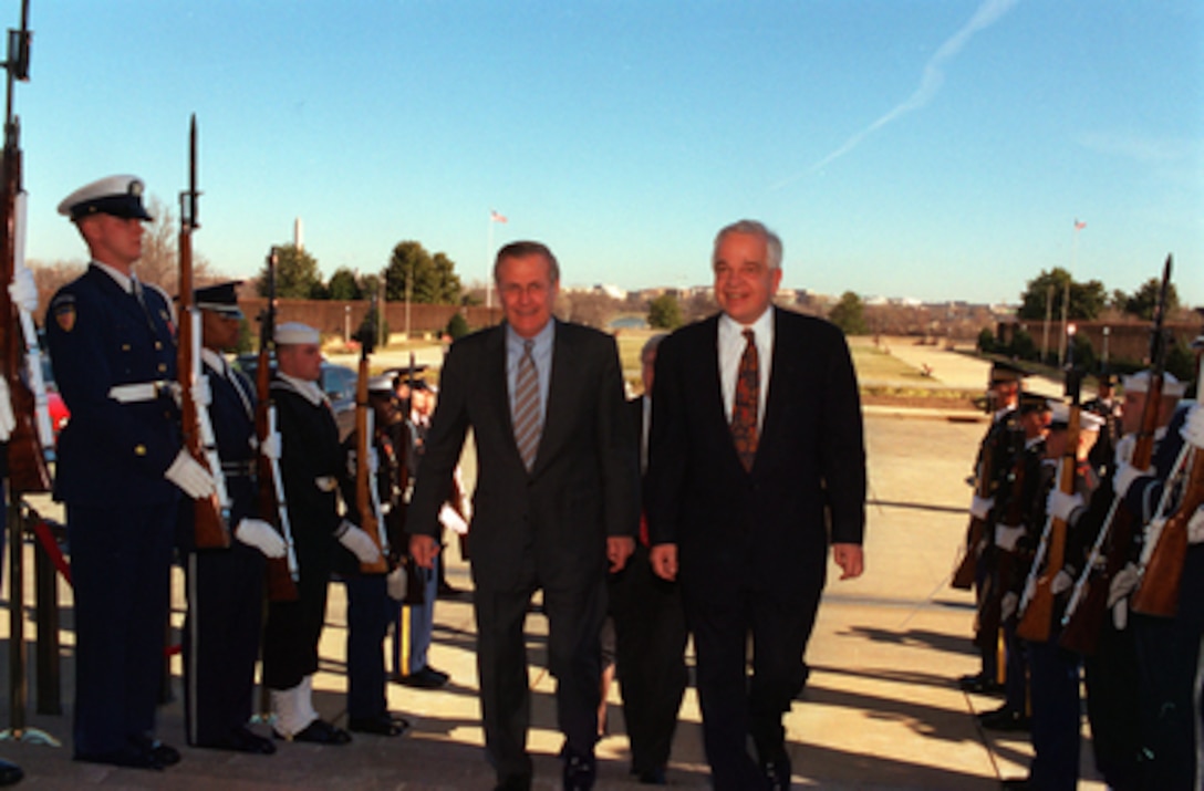 Secretary of Defense Donald H. Rumsfeld escorts Canadian Minister of Defense John McCallum into the Pentagon on Jan. 9, 2003. The two defense leaders met to discuss security issues of mutual interest. 