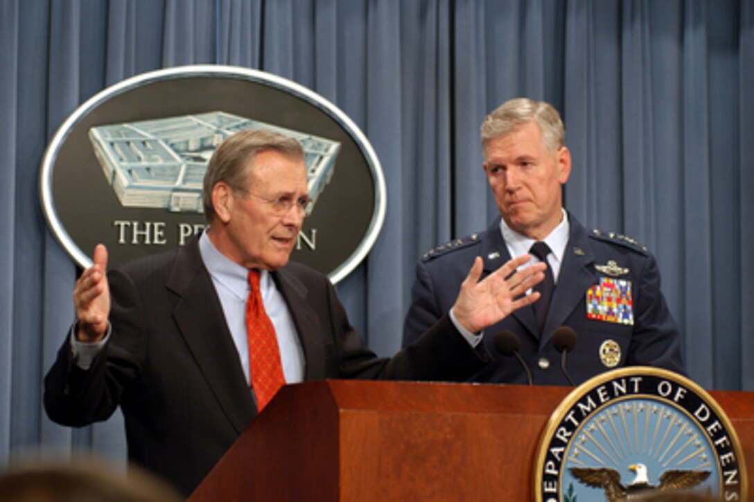 Secretary of Defense Donald H. Rumsfeld responds to a reporter's question concerning the funding for deployments to the Persian Gulf region during a Pentagon press briefing on Jan. 15, 2003. Chairman of the Joint Chiefs of Staff Gen. Richard B. Myers (right), U.S. Air Force, joined Rumsfeld at the briefing to update reporters. 