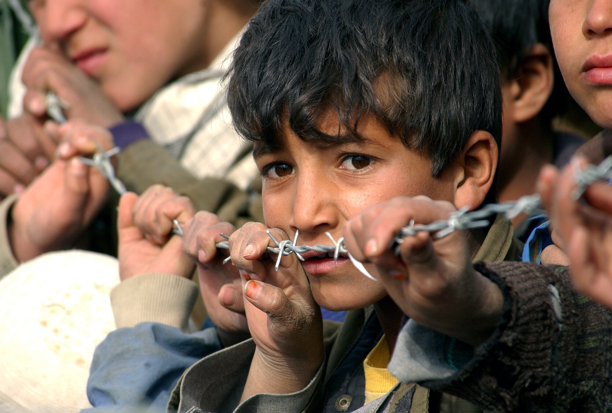 OPERATION ENDURING FREEDOM -- An Afghan boy from the Aroki Province of Kapisa in Afghanistan waits to be seen by U.S. military medics Jan. 21, 2003.  Airmen from the 455th Air Expeditionary Wing, along with soldiers from the 48th Combat Support Hospital and the 924th Korean Medical hospital, visited the province to offer health care to local residents. (U.S. Air Force photo by Staff Sgt. Cherie A. Thurlby)