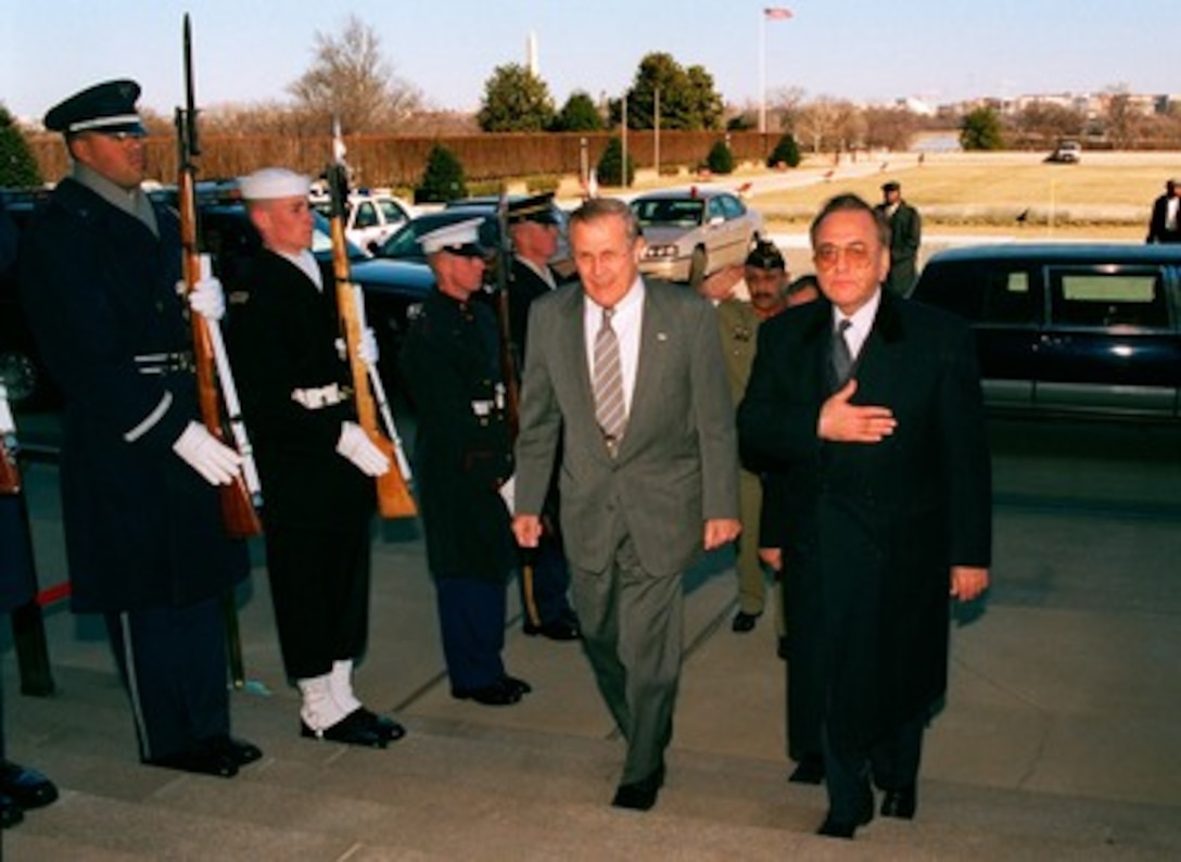 Secretary of Defense Donald H. Rumsfeld (left) escorts Pakistani Minister of Foreign Affairs Mian Khurshid Mahmud Kasuri (right) through an honor cordon and into the Pentagon on Jan. 27, 2003. The two men will hold talks on a range of bilateral security issues. 