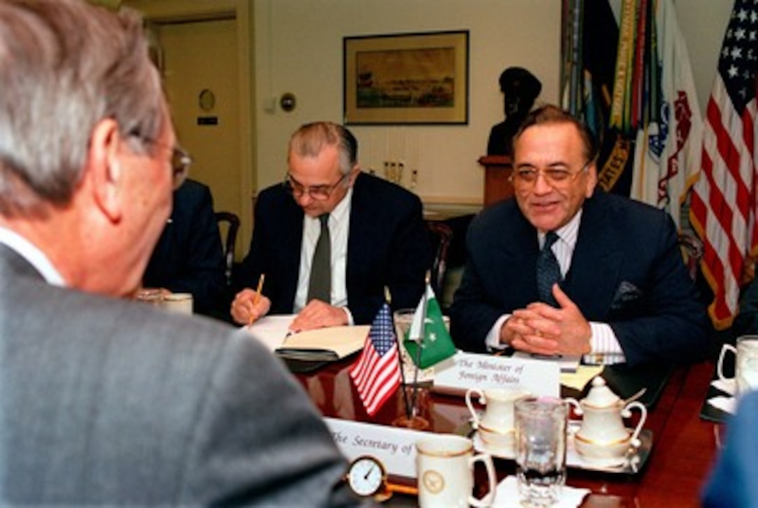 Pakistani Minister of Foreign Affairs Mian Khurshid Mahmud Kasuri (right) meets with Secretary of Defense Donald H. Rumsfeld (foreground) in the Pentagon on Jan. 27, 2003. The two men are meeting to discuss a range of bilateral security issues of interest to both nations. 