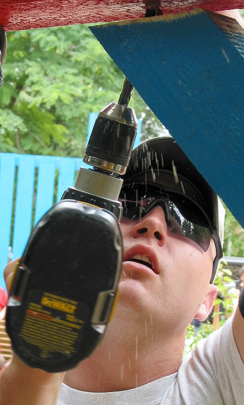 OPERATION ENDURING FREEDOM -- Airman 1st Class Dustin Phillips puts the finishing touches on a swing set.  More than 68 airmen deployed to Ganci Air Base, Kyrgyzstan, helped build a playground for children at the nearby Kyrgyzstan Tuberculosis Research Institute.  Phillips is assigned to the 376th Expeditionary Civil Engineer Squadron at Ganci AB.  (U.S. Air Force photo by Staff Sgt. Jason Smith)