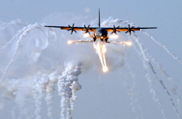 OPERATION IRAQI FREEDOM -- A British C-130J launches flare countermeasures prior to being the first coalition aircraft to land on the reopened military runway at Baghdad International Airport, July 1.  The runway was bombed by coalition aircraft and has been closed since the beginning of the war.  Repaired by the 1st Expeditionary Red Horse Group and the 447th Expeditionary Civil Engineer Squadron it is now operational.  (U.S. Air Force photo by Master Sgt. Robert R. Hargreaves Jr.)