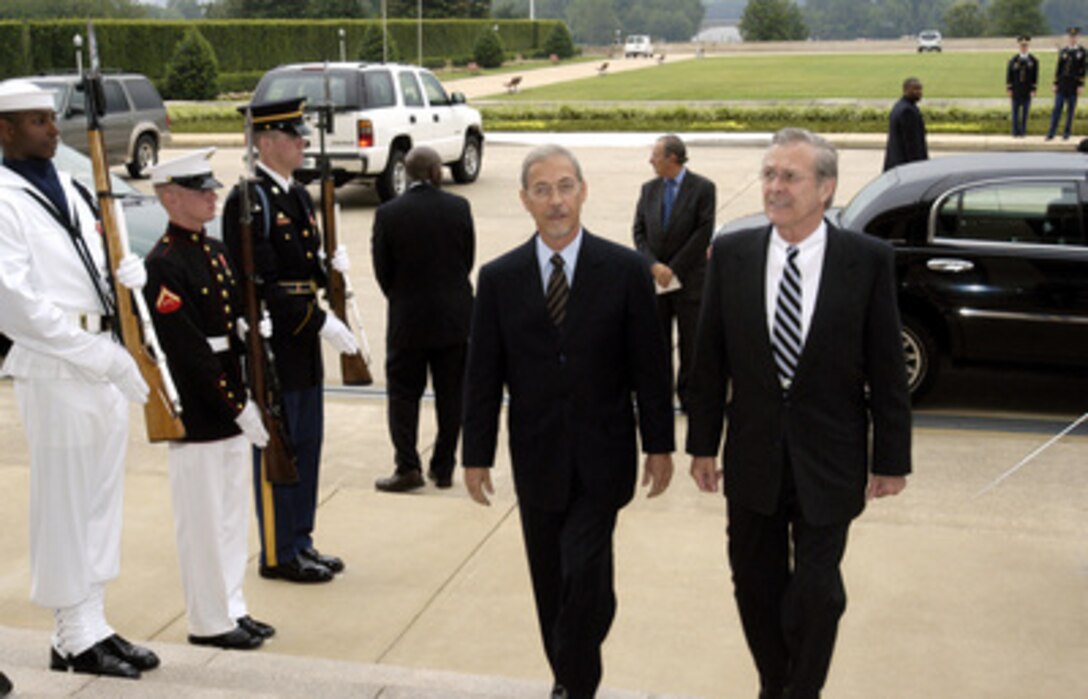 Secretary of Defense Donald H. Rumsfeld (right) escorts Brazilian Minister of Defense Jose Viegas through an honor cordon and into the Pentagon on July 10, 2003. The two defense leaders will meet for the first time to discuss a broad spectrum of regional and global security issues. 