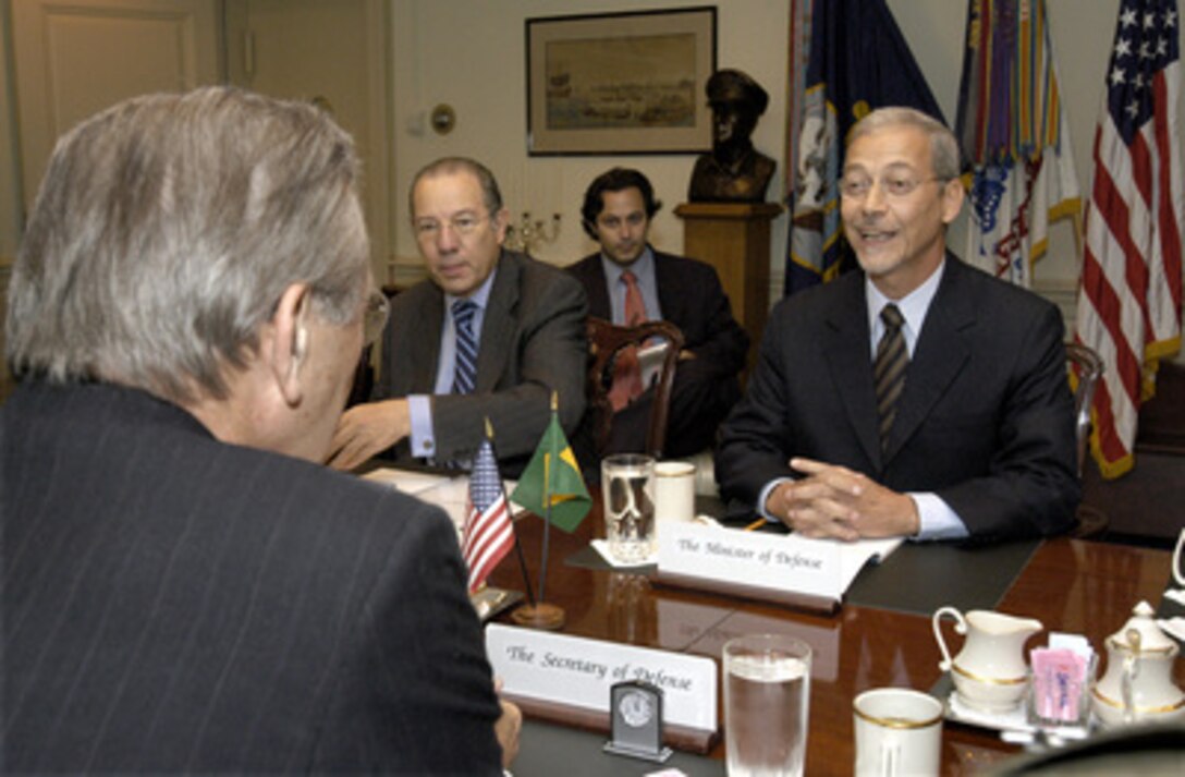 Brazilian Minister of Defense Jose Viegas (right) meets with Secretary of Defense Donald H. Rumsfeld (foreground) in the Pentagon on July 10, 2003. The two defense leaders are meeting for the first time to discuss a broad range of security issues of interest to both nations. Brazilian Ambassador to the United States Rubens Barbosa (center, at the table) joined Viegas and Rumsfeld in the talks. 