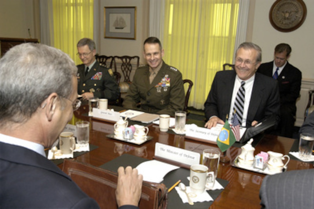 Secretary of Defense Donald H. Rumsfeld (right) hosts a meeting with Brazilian Minister of Defense Jose Viegas (foreground) in the Pentagon on July 10, 2003. The two defense leaders are meeting for the first time to discuss a broad range of security issues of interest to both nations. Lt. Gen. Bantz J. Craddock (left), U.S. Army, senior military assistant to Rumsfeld, and Vice Chairman of the Joint Chiefs of Staff Gen. Peter Pace (center), U.S. Marine Corps, joined in the talks. 