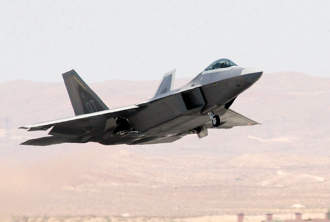 NELLIS AIR FORCE BASE, Nev. -- An F/A-22 Raptor makes a pass over the flightline here July 9.  This is the fourth Raptor to arrive from the factory.  Eventually, 17 of the next-generation stealth fighters will be assigned here.  (U.S. Air Force photo by Tech. Sgt. Kevin J. Gruenwald)