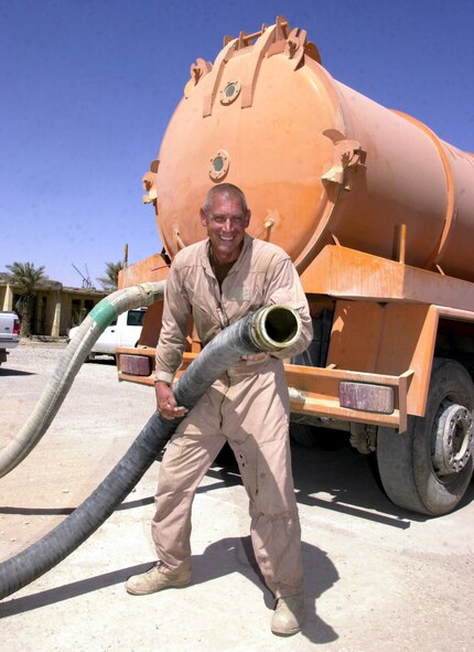 TALLIL AIR BASE, Iraq -- Tech. Sgt. Randall Lovett prepares to service one of more than 100 portable toilets here.  The reservist is assigned to the base's 407th Expeditionary Civil Engineer Squadron.  (U.S. Air Force photo by Master Sgt. Deb Smith)