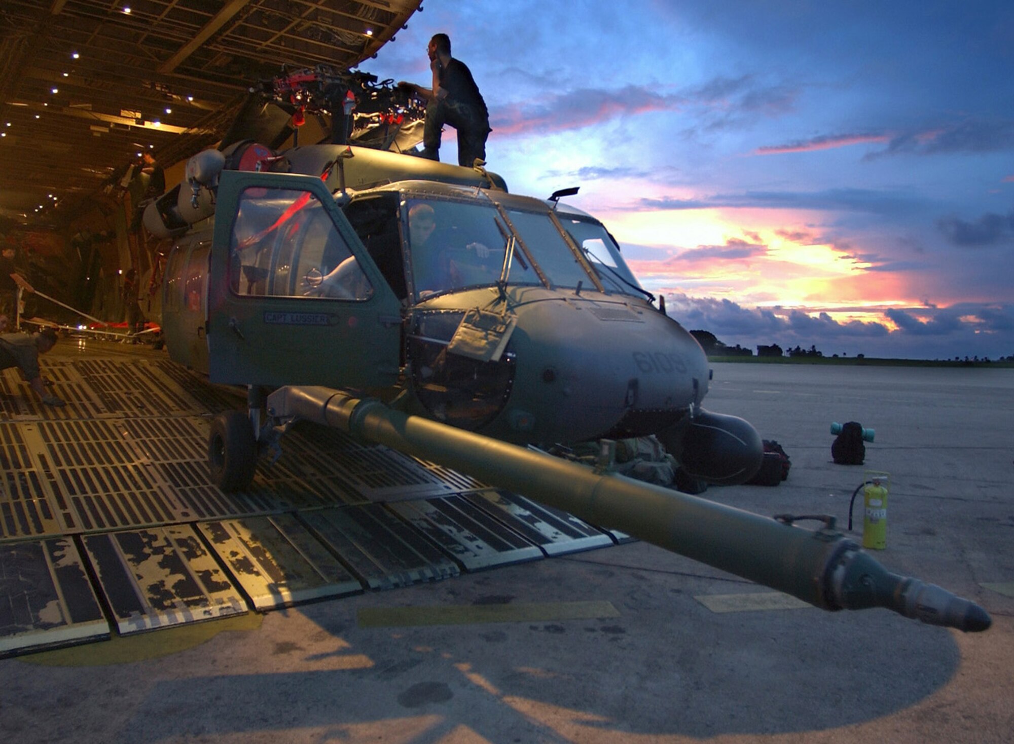 LUNGI, Sierra Leone -- Airmen unload an HH-60G Pave Hawk helicopter from a C-5 Galaxy after arriving here July 13 from Naval Air Station Keflavik, Iceland.  They are providing recovery and emergency evacuation support for the humanitarian assistance survey team in Liberia.  The HH-60G is deployed from the 56th Rescue Squadron at Keflavik, and the C-5 is from the 301st Airlift Squadron at Travis Air Force Base, Calif.  (U.S. Air Force photo by Tech. Sgt. Justin D. Pyle)