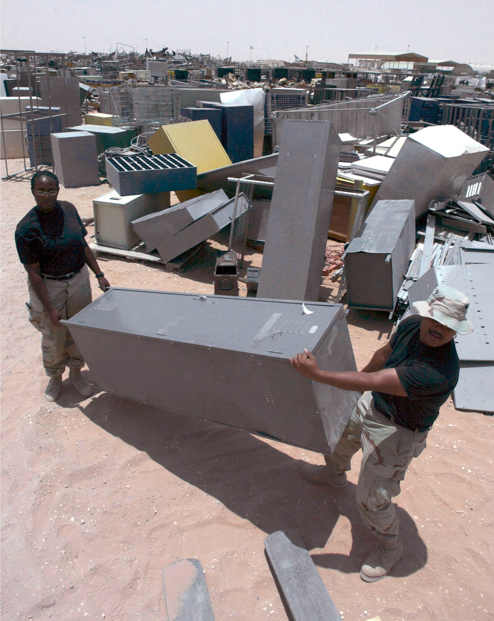 PRINCE SULTAN AIR BASE, Saudi Arabia -- Staff Sgts. Shannon Mathews and Carlos Mora maintain the defense reutilization and marketing office yard here.  They are assigned to the 363rd Expeditionary Logistic Readiness Squadron.  Thousands of items fill the yard from closing sections, units and squadrons as the 363rd Air Expeditionary Wing draws down in Saudi Arabia.  (U.S. Air Force photo by Master Sgt. John E. Lasky)