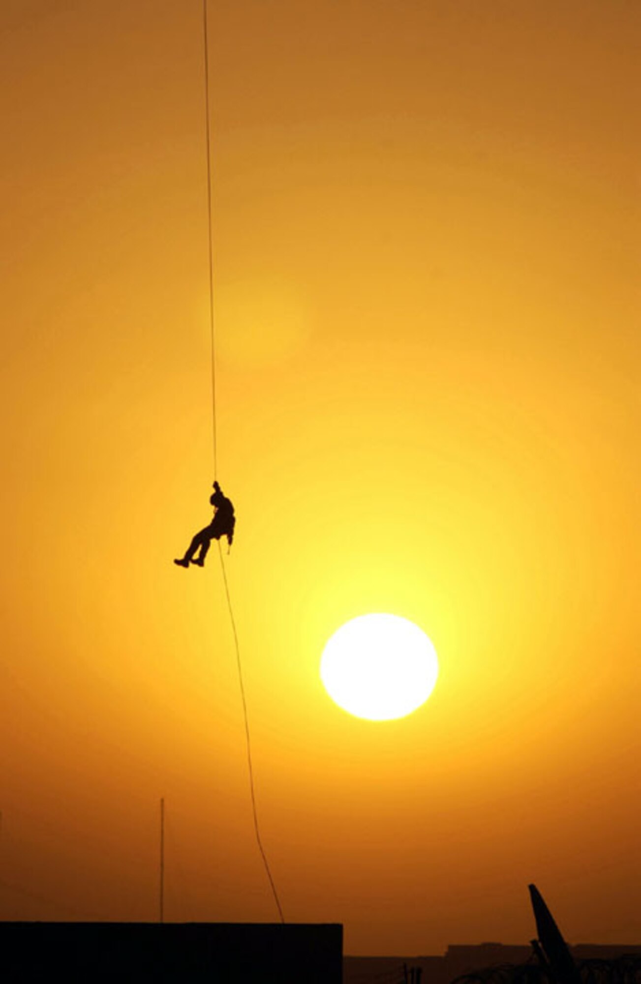 OPERATION IRAQI FREEDOM -- An Air Force Reserve pararescueman assigned to the 304th Rescue Squadron, Portland International Airport, rappels from the Baghdad International Airport air traffic control tower during an exercise.  Squadron airmen are deployed to the airport supporting Operation Iraqi Freedom.  (U.S. Air Force photo by Master Sgt. James M. Bowman)