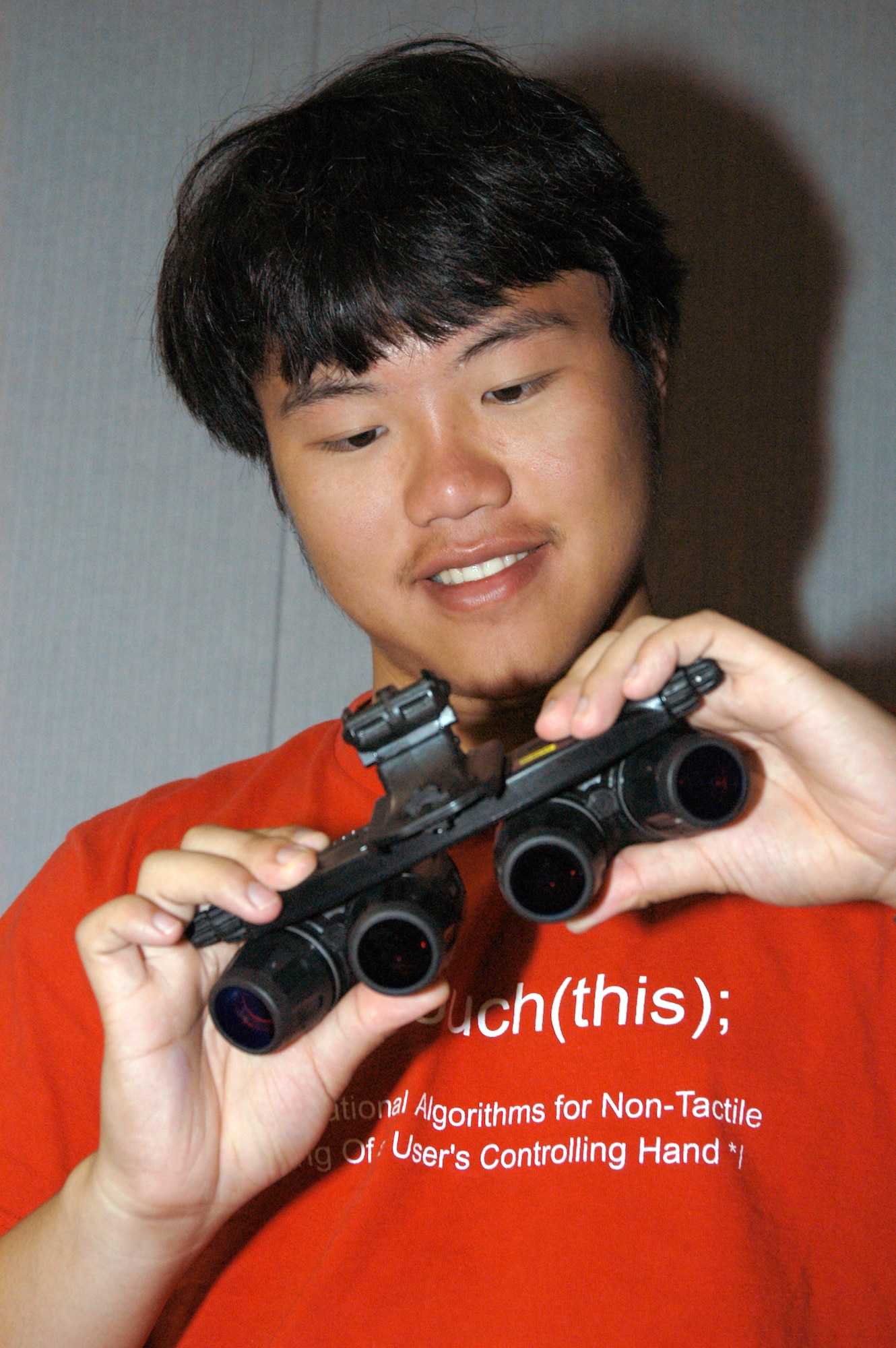 WRIGHT-PATTERSON AIR FORCE BASE, Ohio -- Ray He tours the human effectiveness panoramic night-vision goggles division at the Air Force Research Laboratory here.  He won the Century of Flight Award grand prize of $6,000.  The prize was for his paper titled, "Magnetoplasmadynamics:  Ionization and Magnetic Field -- Improving the Efficiency of Ion Propulsion."  (Courtesy photo)