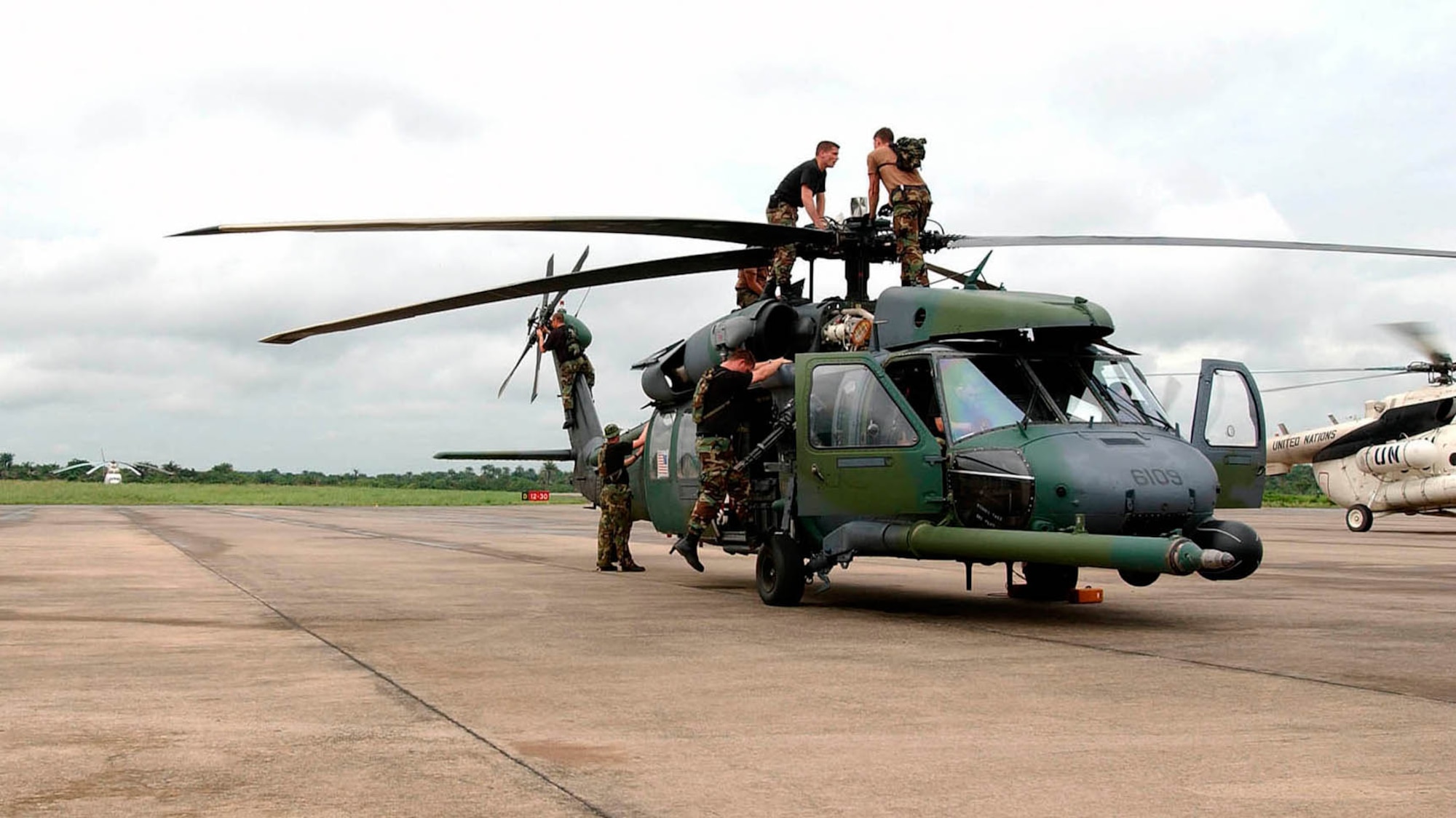 LUNGI, Sierra Leone -- Airmen from the 85th Maintenance Squadron check an Air Force HH-60G Pave Hawk helicopter following a mission July 21.  The mission flew 41 Marines with an antiterrorism security team to the U.S. Embassy at Monrovia, Liberia.  The airmen are part of the 398th Air Expeditionary Group providing recovery and emergency evacuation in Liberia.  The 85th MXS is deployed from Naval Air Station Keflavik, Iceland.  (U.S. Air Force photo by Tech. Sgt. Justin D. Pyle)