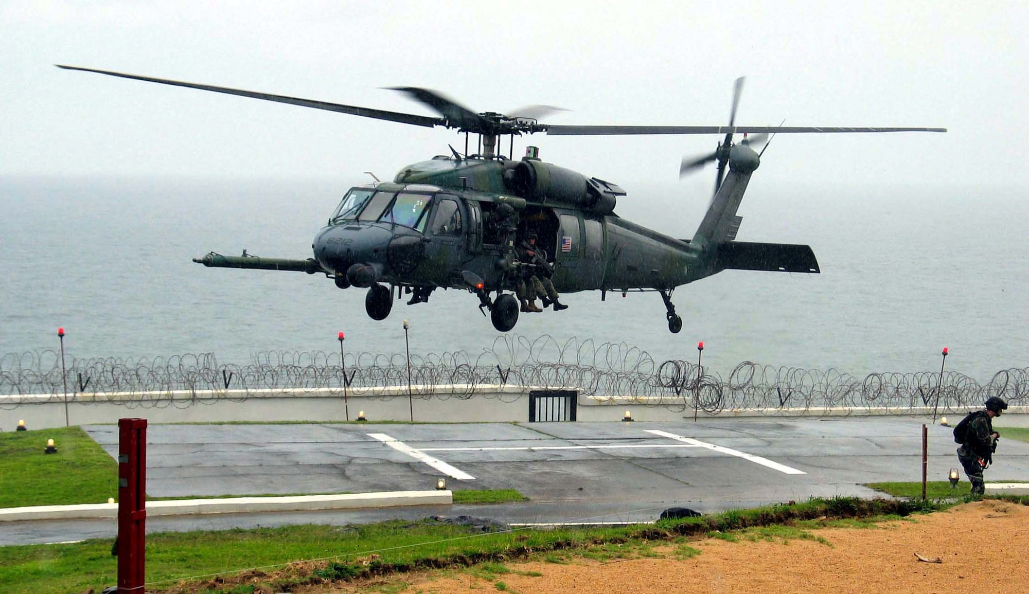 MONROVIA, Liberia -- An Air Force HH-60G Pave Hawk helicopter drops off Marines with an antiterrorism security team at the U.S. Embassy here.  The helicopters also evacuated 23 people during the mission.  The helicopters are deployed to Lungi, Sierra Leone, as part of the 398th Air Expeditionary Group.  The group provides recovery and emergency evacuation capabilities in Liberia. (U.S. Air Force photo by Maj. Brett Hartnett)