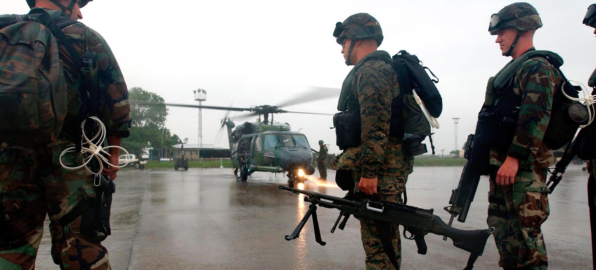 LUNGI, Sierra Leone -- Marines prepare to board an Air Force HH-60G Pave Hawk helicopter here July 21.  The Marines are part of an antiterrorism security team augmenting security at the U.S. Embassy in Monrovia, Liberia.  The helicopters are deployed form Naval Air Station Keflavik, Iceland, as part of the 398th Air Expeditionary Group.  The group provides recovery and emergency evacuation capabilities in Liberia.  (U.S. Air Force photo by Tech. Sgt. Justin D. Pyle)