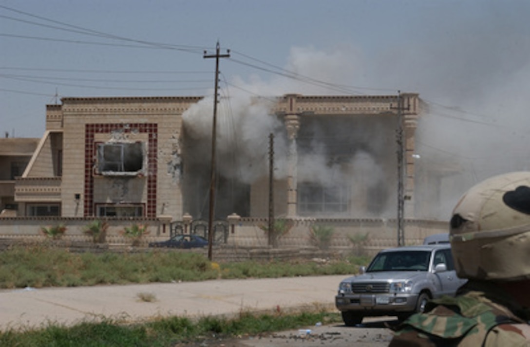 A cloud of dust and smoke billows out from a building hit with a TOW missile launched by soldiers of the Army's 101st Airborne Division (Air Assault) on July 22, 2003, in Mosul, Iraq. Saddam Hussein's sons Qusay and Uday were killed in a gun battle as they resisted efforts by coalition forces to apprehend and detain them. 