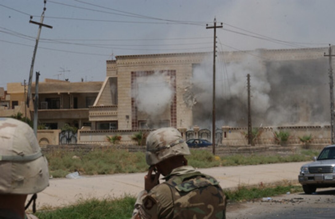 A cloud of dust and smoke billows out from a building hit with a TOW missile launched by soldiers of the Army's 101st Airborne Division (Air Assault) on July 22, 2003, in Mosul, Iraq. Saddam Hussein's sons Qusay and Uday were killed in a gun battle as they resisted efforts by coalition forces to apprehend and detain them. 