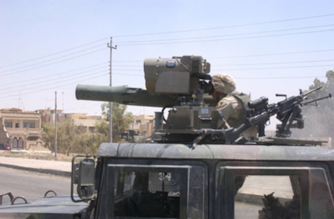 A soldier of the 101st Airborne Division (Air Assault) looks through the sights of a TOW missile launcher at a building suspected of harboring Saddam Hussein's sons Qusay and Uday in Mosul, Iraq, on July 22, 2003. Qusay and Uday were killed in a gun battle as they resisted efforts by coalition forces to apprehend and detain them. 