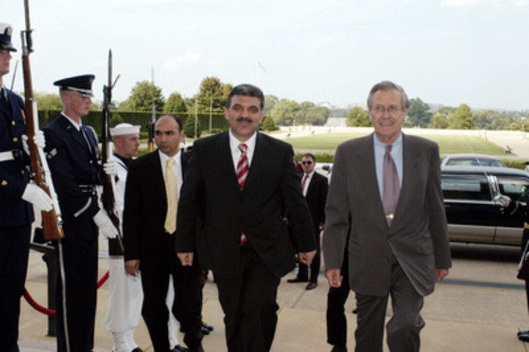 Secretary of Defense Donald H. Rumsfeld escorts Deputy Prime Minister and Minister of Foreign Affairs of the Republic of Turkey Abdullah Gul into the Pentagon on July 24, 2003. The two leaders will meet to discuss security issues of mutual interest. 