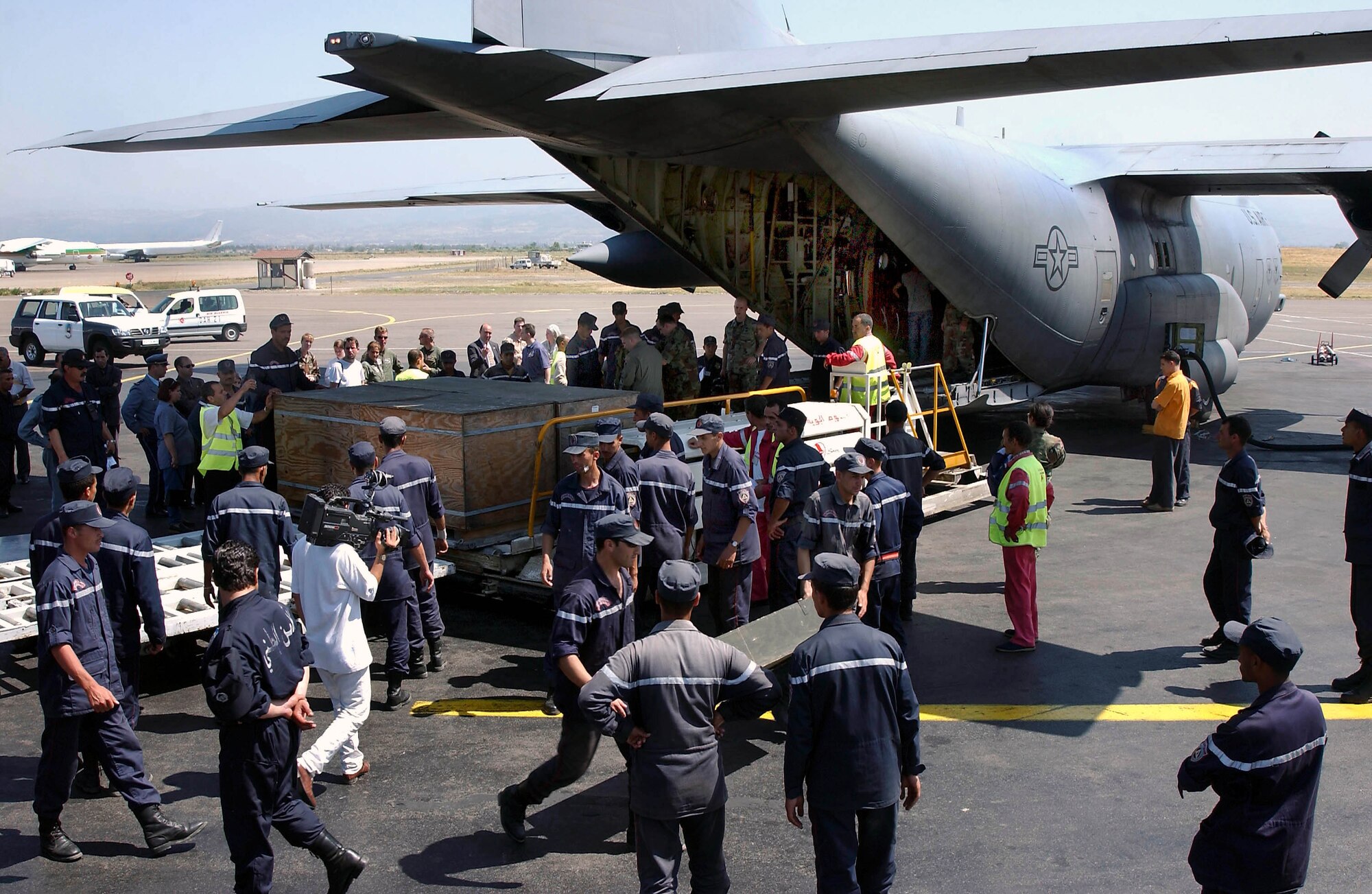 ALGIERS, Algeria -- Algerian workers unload 15,000 pounds of medical supplies, beds and tents for earthquake victims here.  Reservists from the 773rd Airlift Squadron at Youngston, Ohio, and deployed to the 86th Airlift Wing at Ramstein Air Base, Germany, delivered the goods May 30.  (U.S. Air Force photo by Master Sgt. Keith Reed)