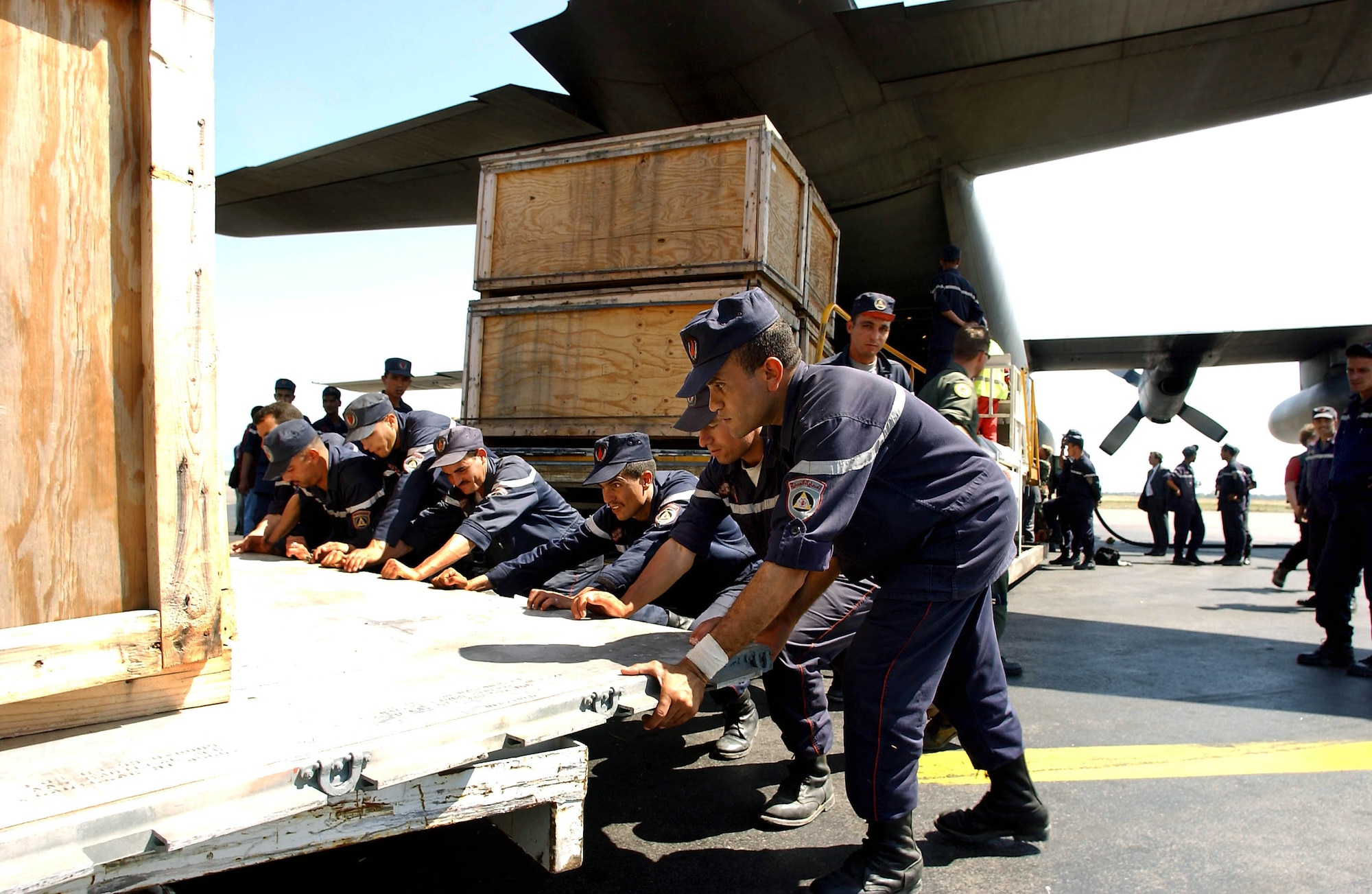 ALGIERS, Algeria -- Algerian workers unload 15,000 pounds of medical supplies, beds and tents for earthquake victims here.  Reservists from the 773rd Airlift Squadron at Youngston, Ohio, and deployed to the 86th Airlift Wing at Ramstein Air Base, Germany, delivered the goods May 30.  (U.S. Air Force photo by Master Sgt. Keith Reed)
