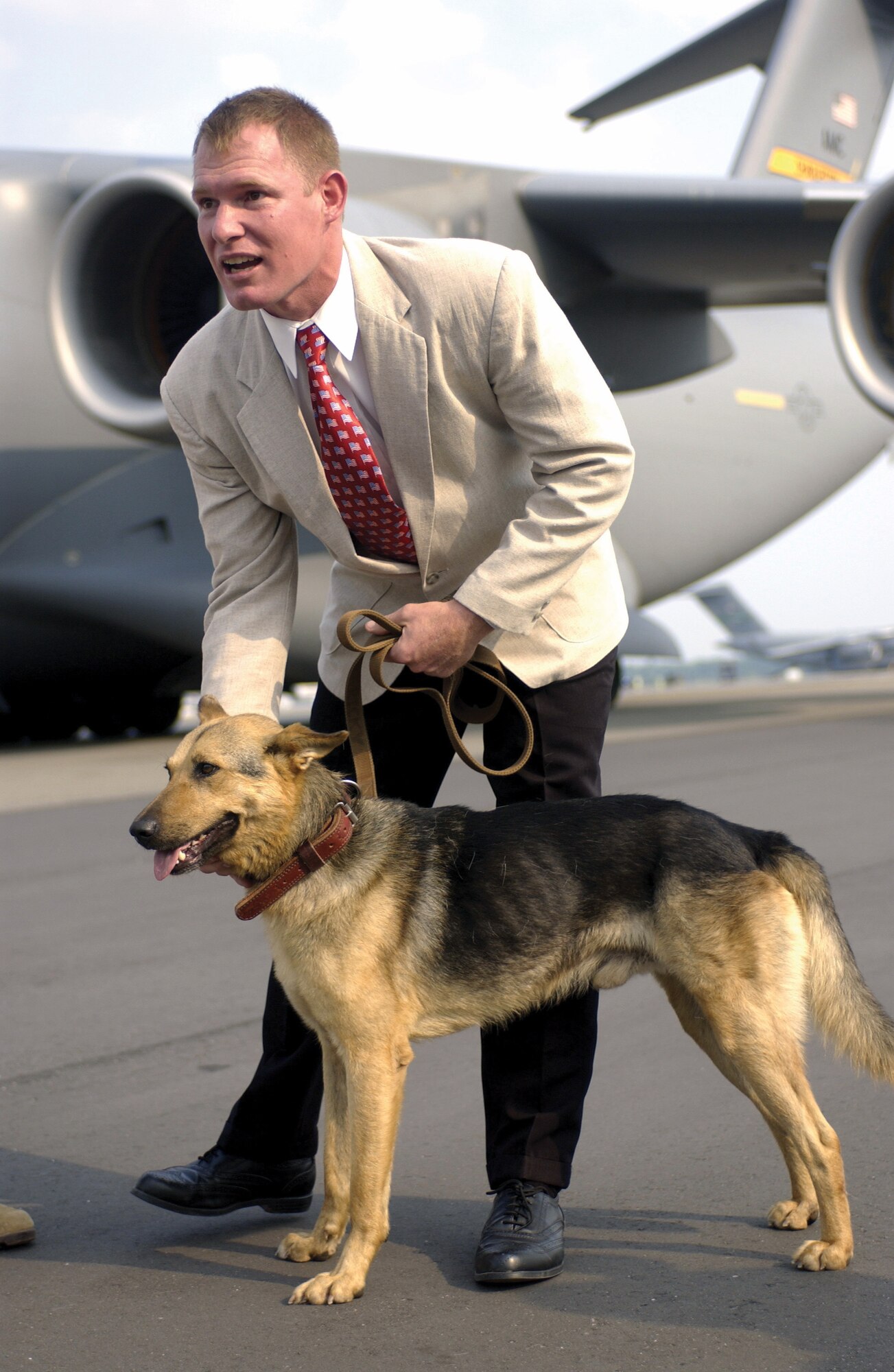CHARLESTON AIR FORCE BASE, S.C. -- Army Sgt. 1st Class Russell Joyce is reunited with his former partner, Fluffy, on the flightline here.  Fluffy put his life on the line guarding U.S. special forces and received permission to immigrate to the United States. (U.S. Air Force photo by Staff Sgt. Jeffrey A. Wolfe)