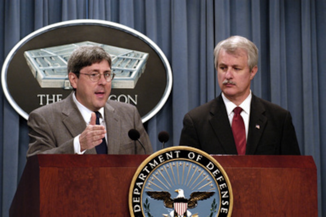 Under Secretary of Defense for Policy Douglas Feith (left) and Deputy Under Secretary of Defense for Near Eastern South Asian Affairs and Special Plans William Luti brief reporters on policy and intelligence during a Pentagon press conference on June 4, 2003. 