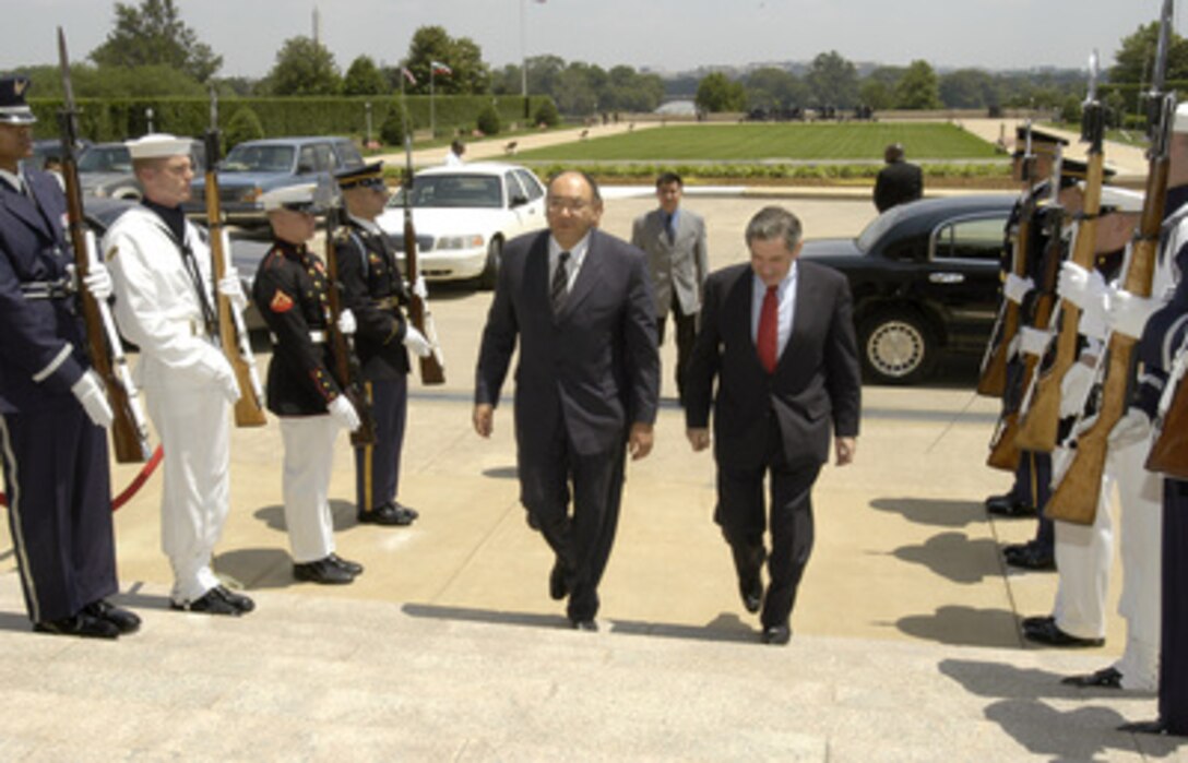 Deputy Secretary of Defense Paul Wolfowitz (right) escorts Kyrgyzstan's Minister of Foreign Affairs Askar Aitmatov (left) through an honor cordon as he arrives at the Pentagon on June 5, 2003. Wolfowitz and Aitmatov will meet to discuss a broad range of regional security issues. 
