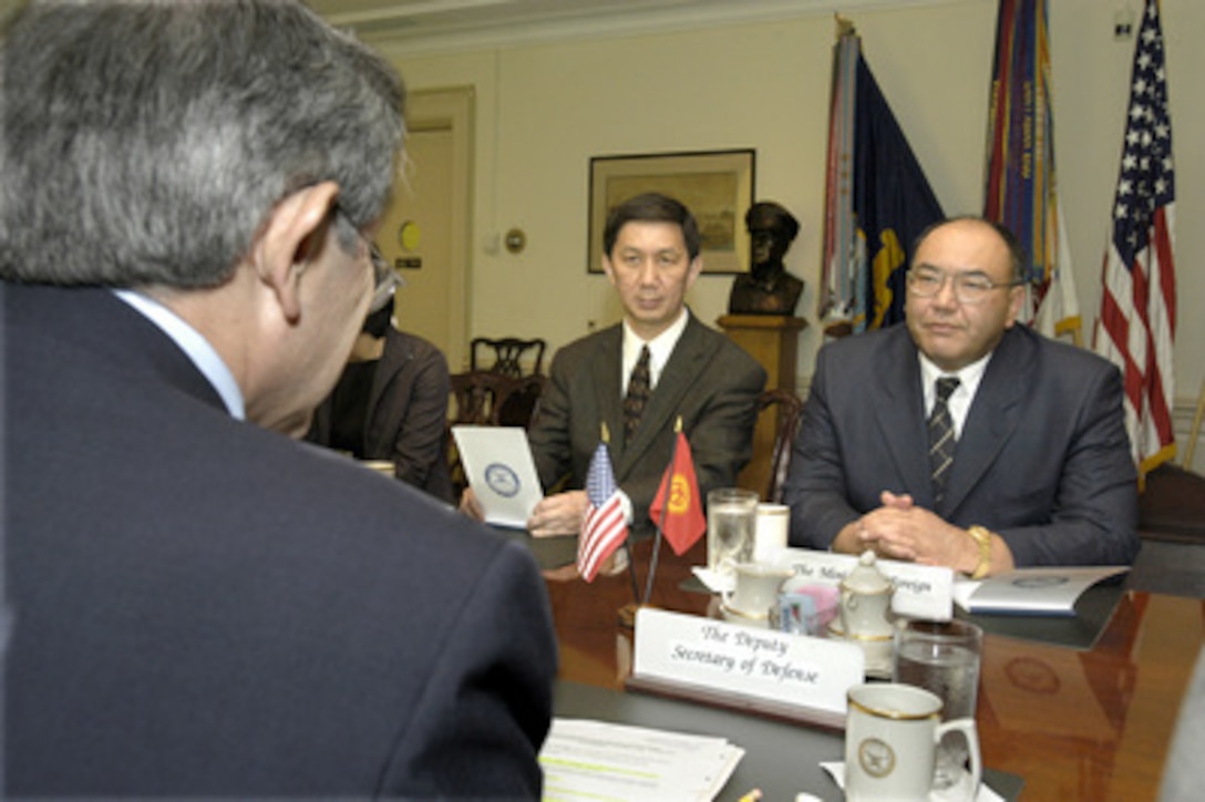 Kyrgyzstan's Minister of Foreign Affairs Askar Aitmatov (right) meets with Deputy Secretary of Defense Paul Wolfowitz (foreground) in the Pentagon on June 5, 2003. Kyrgyzstan's Ambassador to the United States Bakyt Abdrisayev (center) joined Aitmatov and Wolfowitz as they discussed a broad range of regional security issues. 