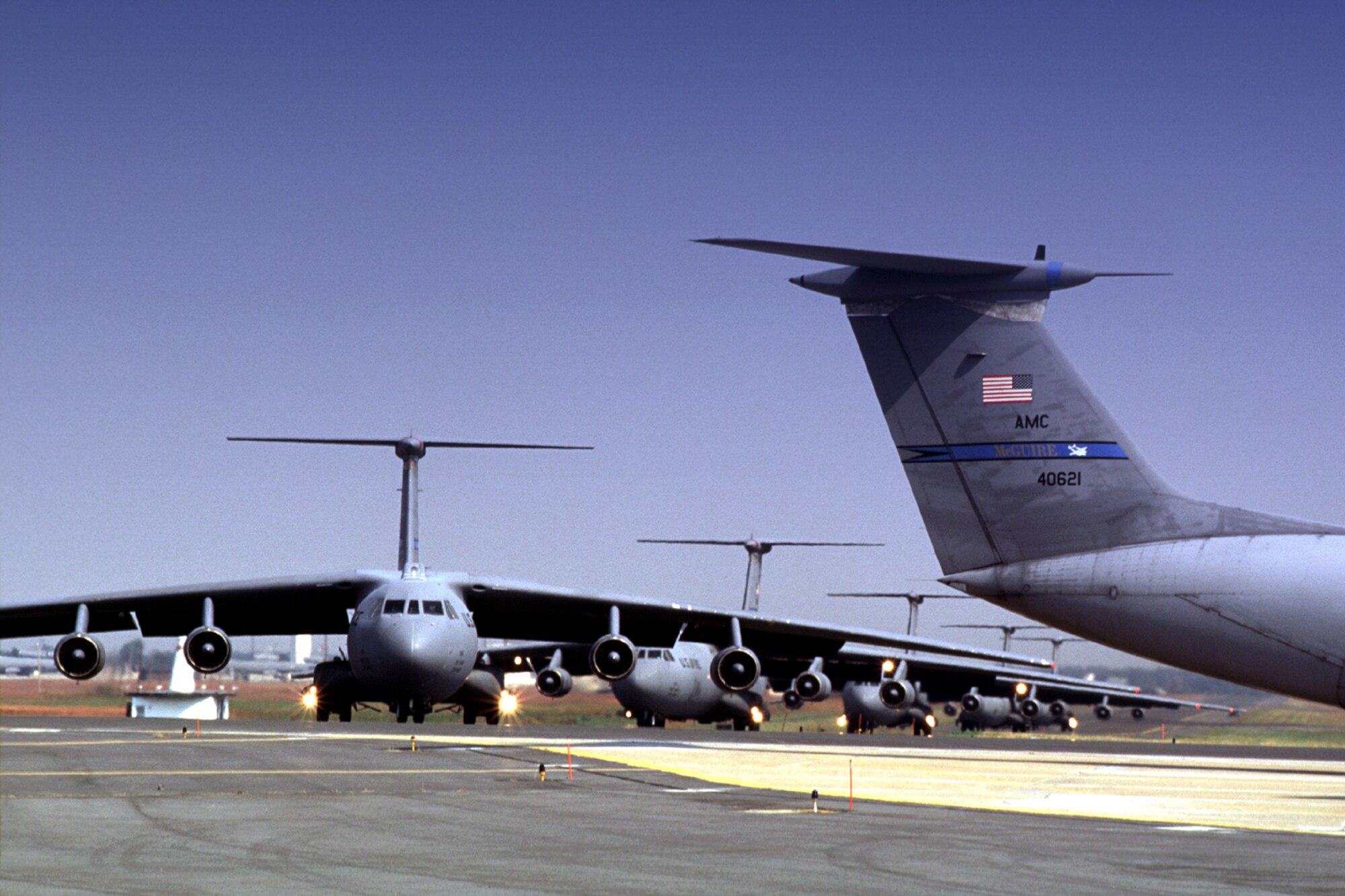 MCGUIRE AIR FORCE BASE, N.J. (AFPN) - C-141 Starlifters taxi down the runway here.  Although the 6th Airlift Squadron is being drawn down to make way for the C-17 Globemaster III, its operations tempo has been on the rise.  (U.S. Air Force photo by John Sidoriak Jr.)