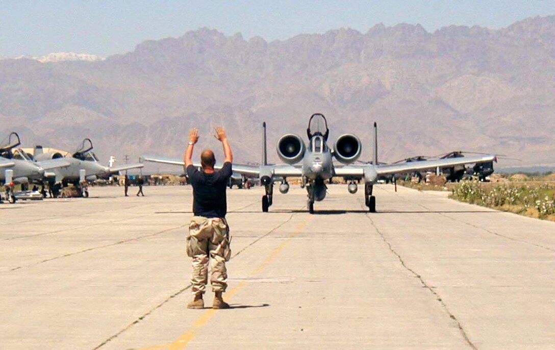 OPERATION ENDURING FREEDOM (AFPN) -- A crew chief from the 455th Expeditionary Operations Group at Bagram Air Base, Afghanistan, marshals an A-10 Thunderbolt II pilot to a parking spot.  The 52nd Fighter Wing at Spangdahlem AB, Germany, deployed about 150 people and eight A-10s to Bagram to assume the close-air support mission from the Maryland Air National Guard.  (U.S. Air Force photo by Tech. Sgt. Eric M. Grill)