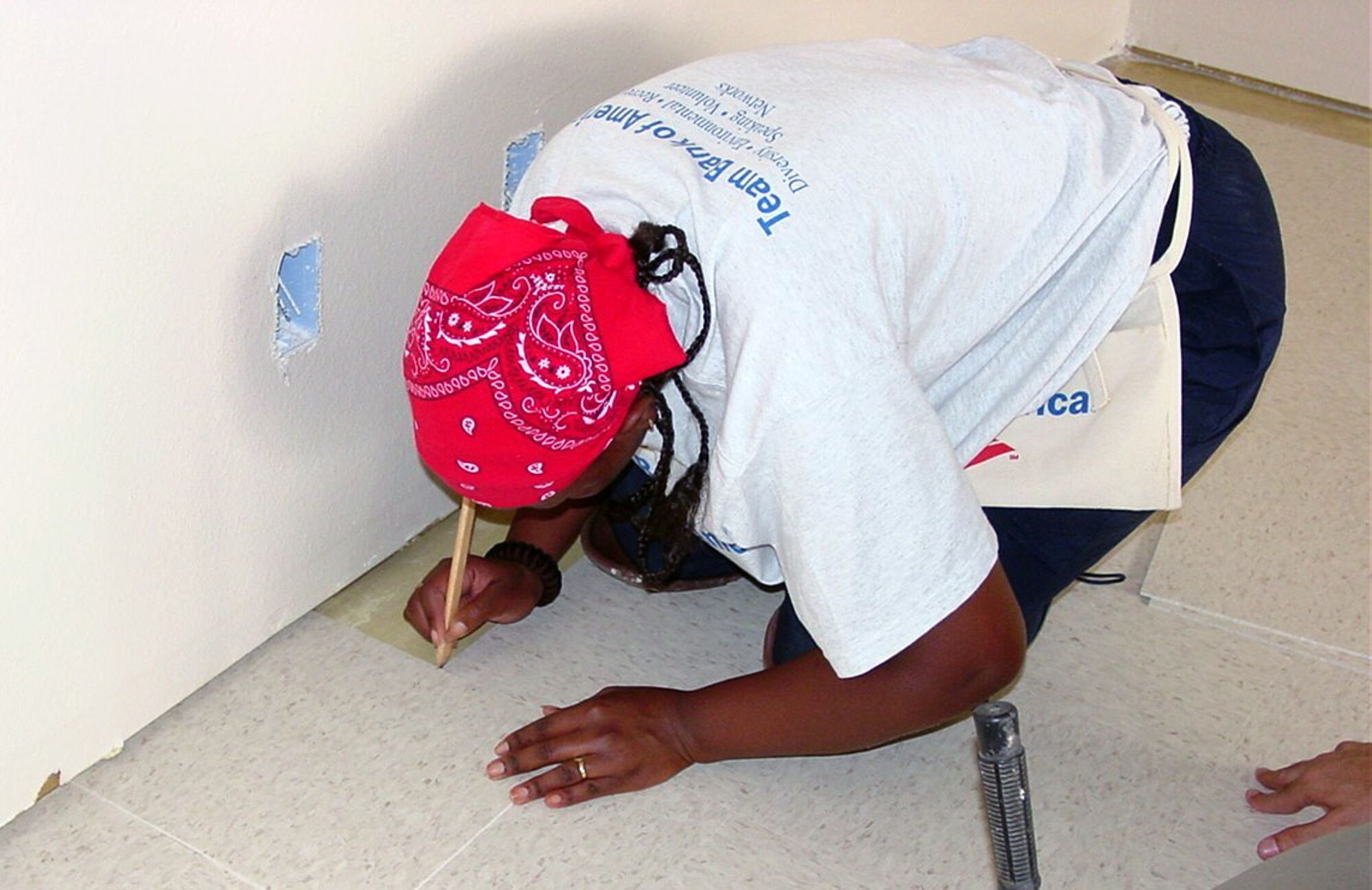LACKLAND AIR FORCE BASE, Texas -- Namibia army Corporal Julia Gebhardt used exacting detail laying tile as she contributed her skills working side-by-side American volunteers and her fellow international military students.  (U.S. Air Force photo by Annette D. Janetzke)