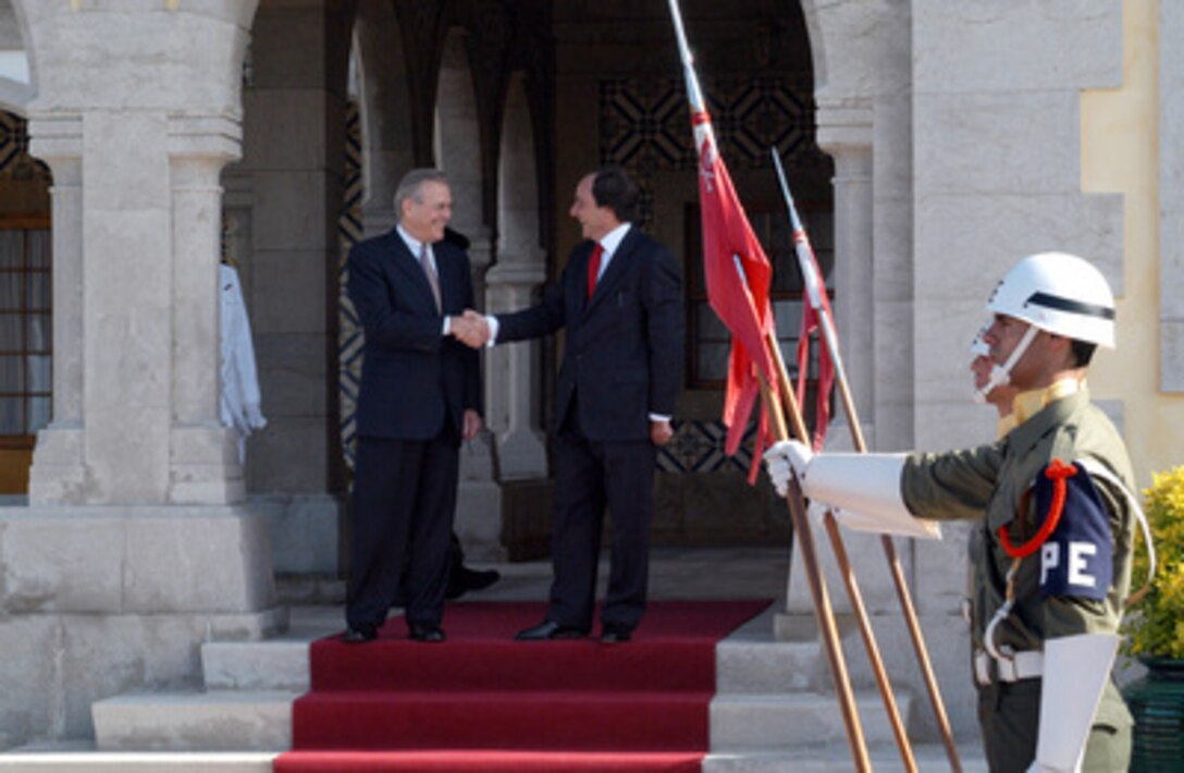 Portuguese Minister of State & Defense Paulo Portas (right) welcomes Secretary of Defense Donald H. Rumsfeld to his official residence at Fort Sao Juliao in Lisbon, Portugal, for bilateral security discussions on June 10, 2003. Rumsfeld is in Europe on a four-day trip to meet with allies and attend the annual spring meeting of NATO defense ministers in Brussels, Belgium. 