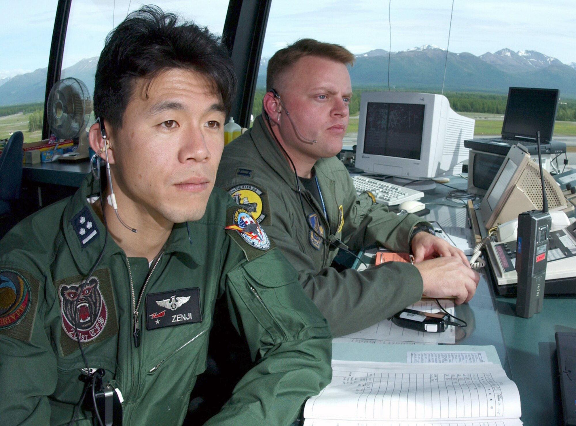 ELMENDORF AIR FORCE BASE, Alaska (AFPN) - Japanese Capt. Yoshifumi Nakamura, an F-15 pilot, and Capt. Barley Baldwin, from the 12th Fighter Squadron here, supervise flying operations from the air traffic control tower as Japanese aircraft taxi for take off during Cooperative Cope Thunder.  (U.S. Air Force photo by Tech. Sgt. Keith Brown)