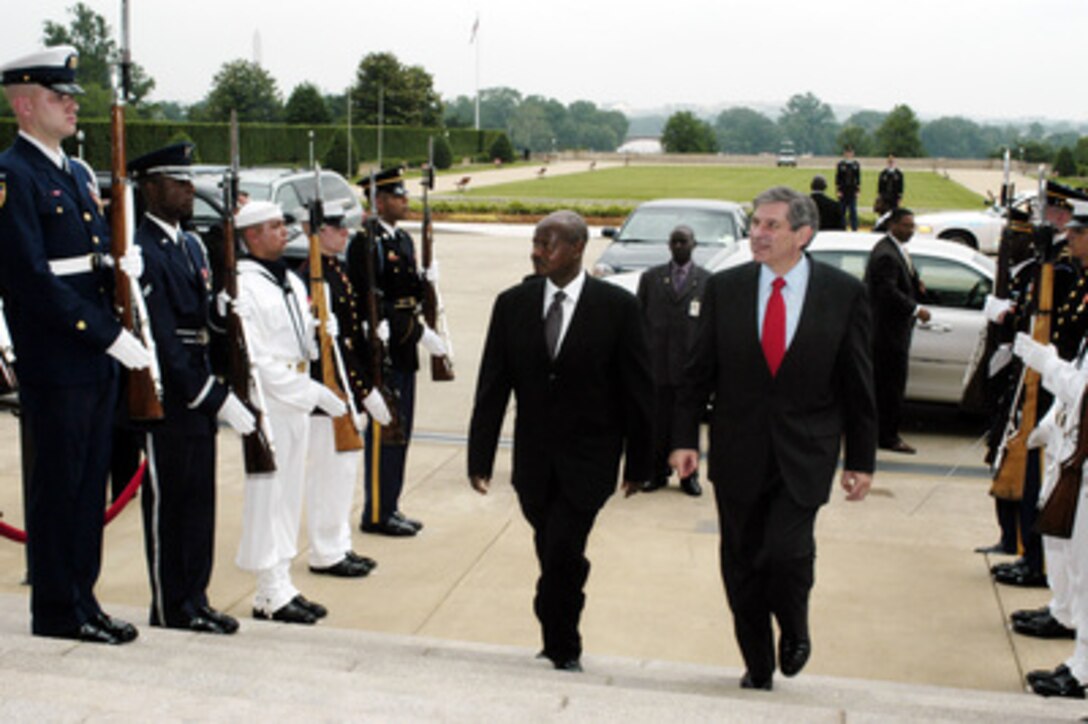 Deputy Secretary of Defense Paul Wolfowitz (right) escorts Ugandan President Yoweri Kaguta Museveni through an honor cordon and into the Pentagon on June 13, 2003. 