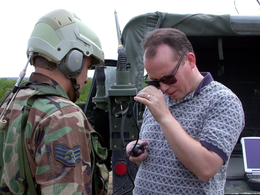 WRIGHT-PATTERSON AIR FORCE BASE, Ohio (AFPN) -- Dr. David Darkow explains the R2 helmet to Staff Sgt. Roman Lopez, who is assigned to the Air Combat Command Tactical Air Control Party.  The helmet is designed to increase a user's efficiency, effectiveness and situational awareness on the battlefield.  It includes audio, visual and computer-aided enhancements.  Darkow is assigned to the Air Force Research Laboratory's human effectiveness directorate here.  (U.S. Air Force photo by 2nd Lt. J. Elaine Hunnicutt)