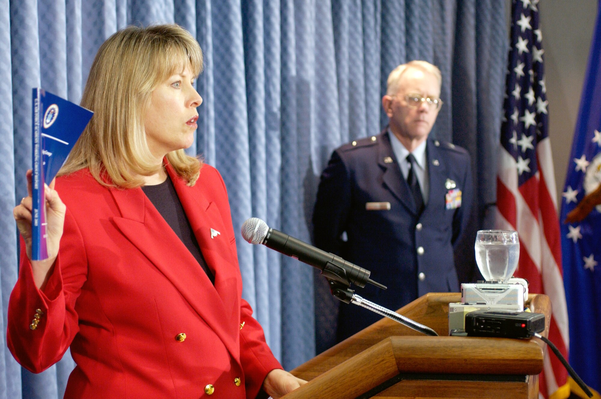 WASHINGTON -- Air Force General Counsel Mary L. Walker (left) holds a copy of the report on the U.S. Air Force Academy sexual misconduct study released June 19 during a press briefing here.  She is joined by Brig. Gen. Ron Rand, director of Air Force public affairs.  (U.S. Air Force photo by Master Sgt. Jim Varhegyi)