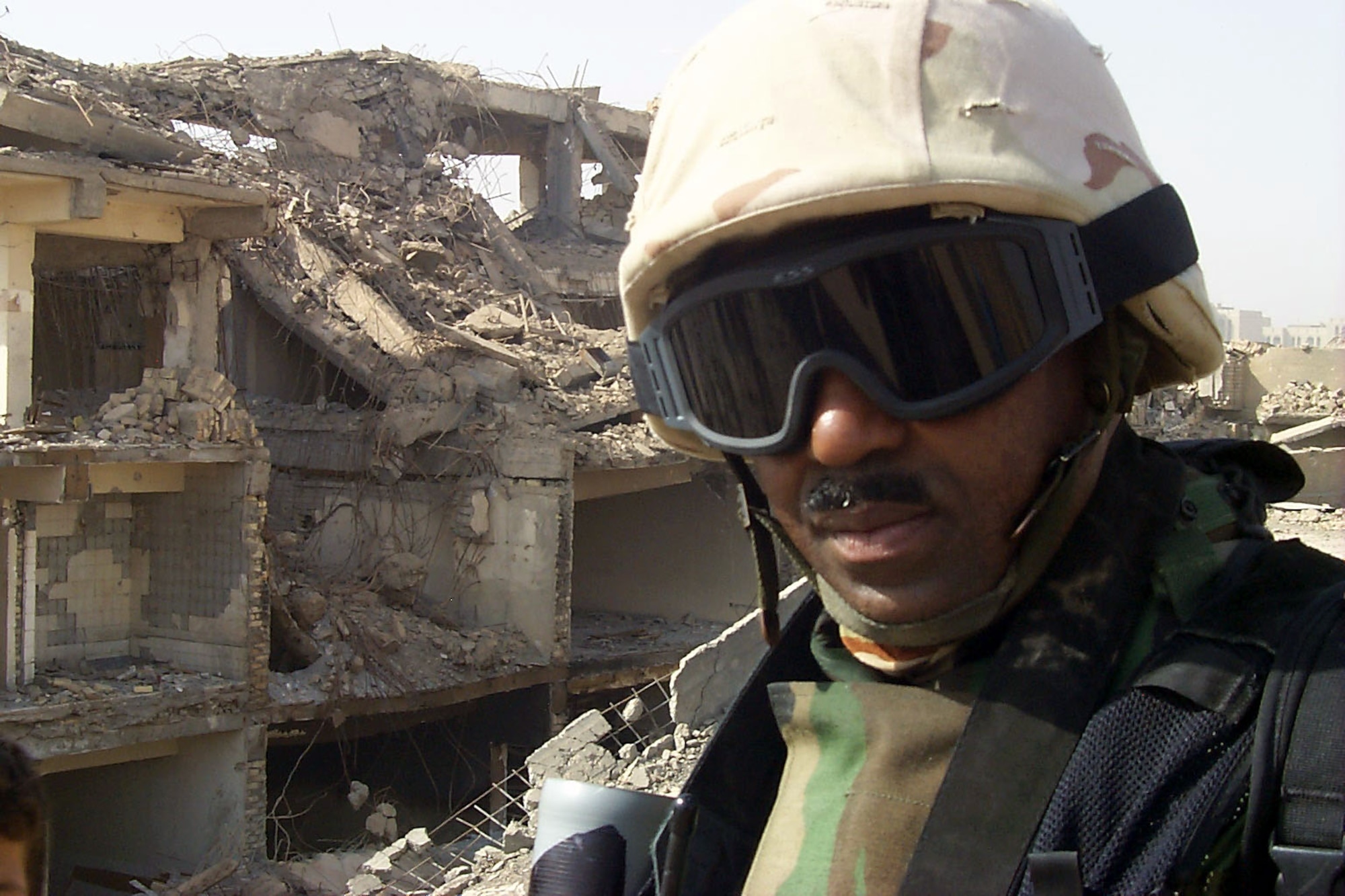 BAGHDAD, Iraq -- Master Sgt. Michael Best stands amidst the rubble of what was formerly the Iraqi Ministry of Defense complex here.  Best is a combat-camera photographer deployed from Charleston Air Force Base, S.C.  (U.S. Air Force photo by Capt. Roger Burdette)