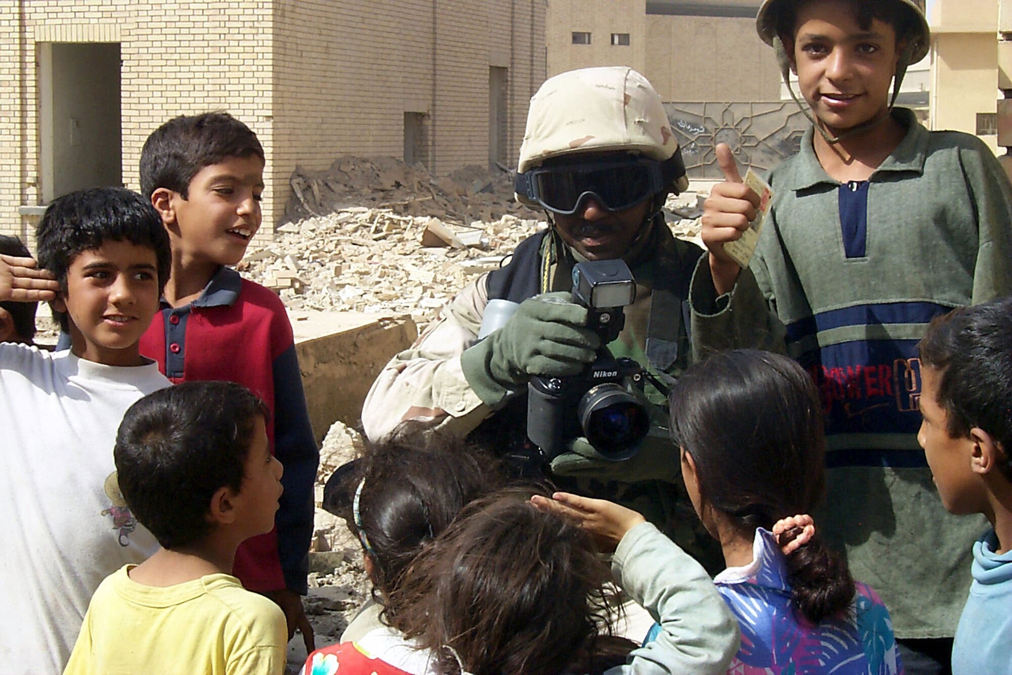 BAGHDAD, Iraq -- Master Sgt. Michael Best shares pictures he had taken of Iraqi children who now live on the grounds of the Iraqi Ministry of Defense here.  Best is a combat-camera photographer deployed from Charleston Air Force Base, S.C.  (U.S. Air Force photo by Capt. Roger Burdette)