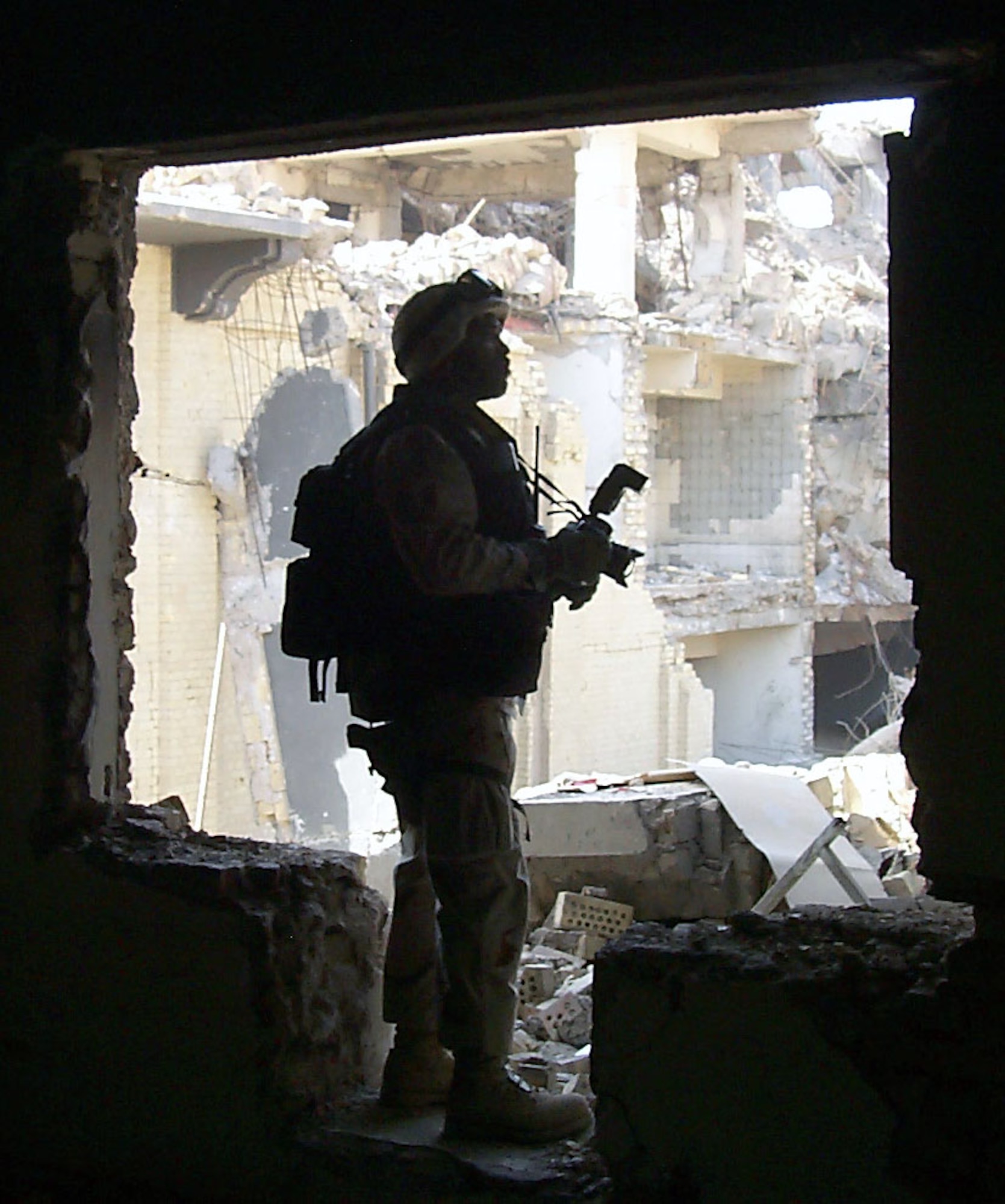 BAGHDAD, Iraq -- Master Sgt. Michael Best searches for photo opportunities inside a bomb-damaged Iraqi Ministry of Defense building here.  Best is a combat-camera photographer deployed from Charleston Air Force Base, S.C.  (U.S. Air Force photo by Capt. Roger Burdette)