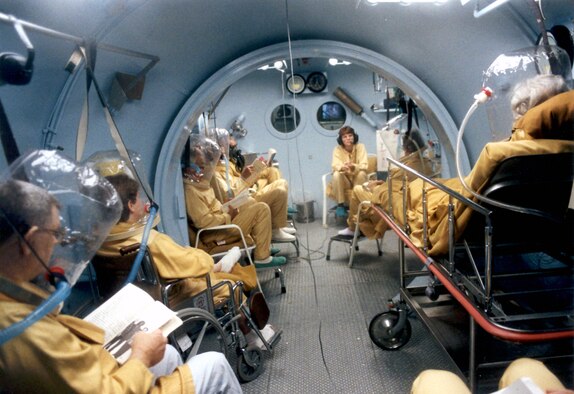 BROOKS CITY-BASE, Texas -- Patients receive hyperbaric oxygen therapy in the U.S. Air Force School of Aerospace Medicine's hyperbaric medicine division, also known as the Davis Hyperbaric Laboratory.  At center is an Air Force technician who monitors the conditions of the patients during the treatment process.  The laboratory recently became the first nationally accredited Department of Defense hyperbaric facility.  (Courtesy photo)