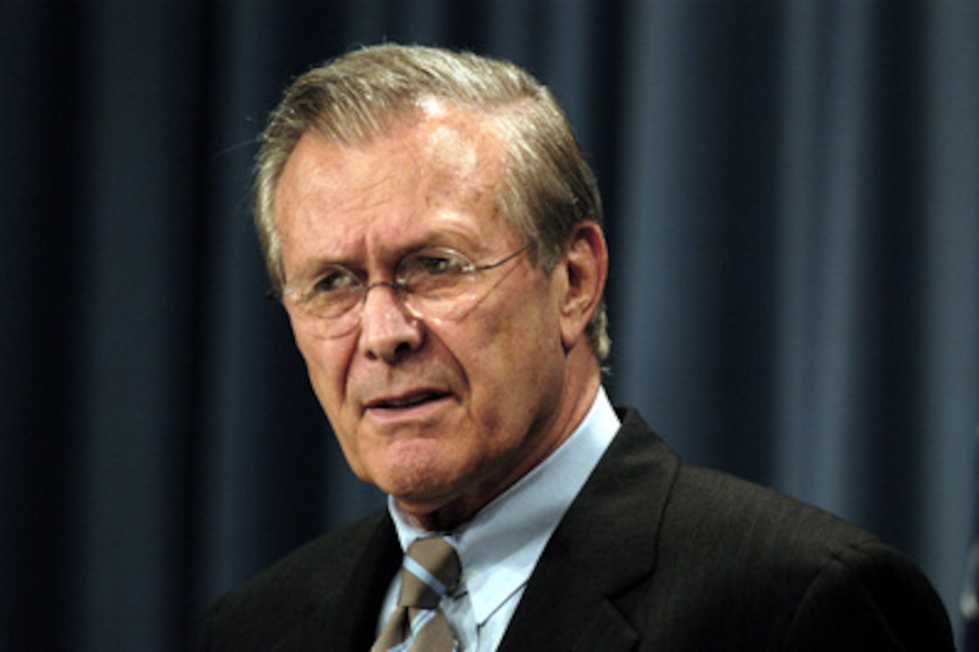 Secretary of Defense Donald H. Rumsfeld listens to a reporter during a Pentagon press briefing June 24, 2003. 