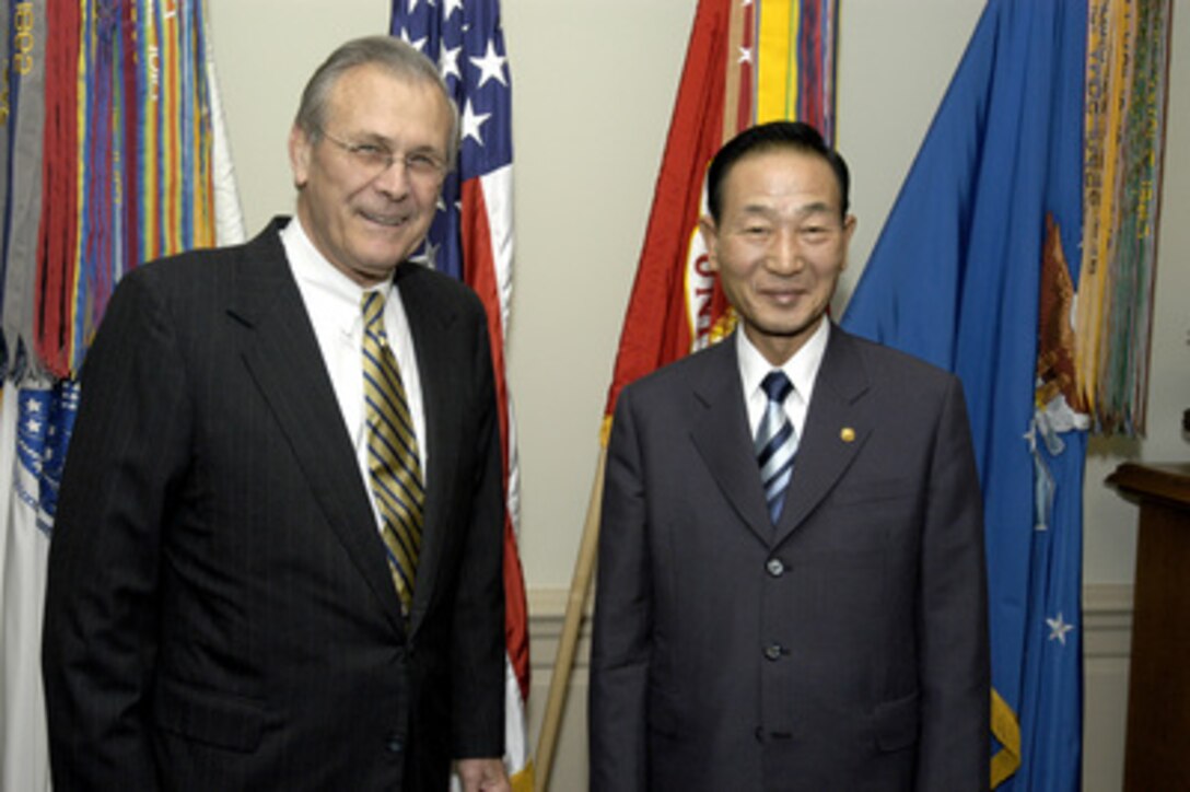 Secretary of Defense Donald H. Rumsfeld (left) poses for photos with South Korean Minister of National Defense Cho Yong-kil at the Pentagon June 27, 2003. Immediately following the photo opportunity, the two defense leaders held private, bilateral, discussions on a broad range of security issues. Later the two defense leaders continued their meetings, this time including senior staff advisors in the talks. 