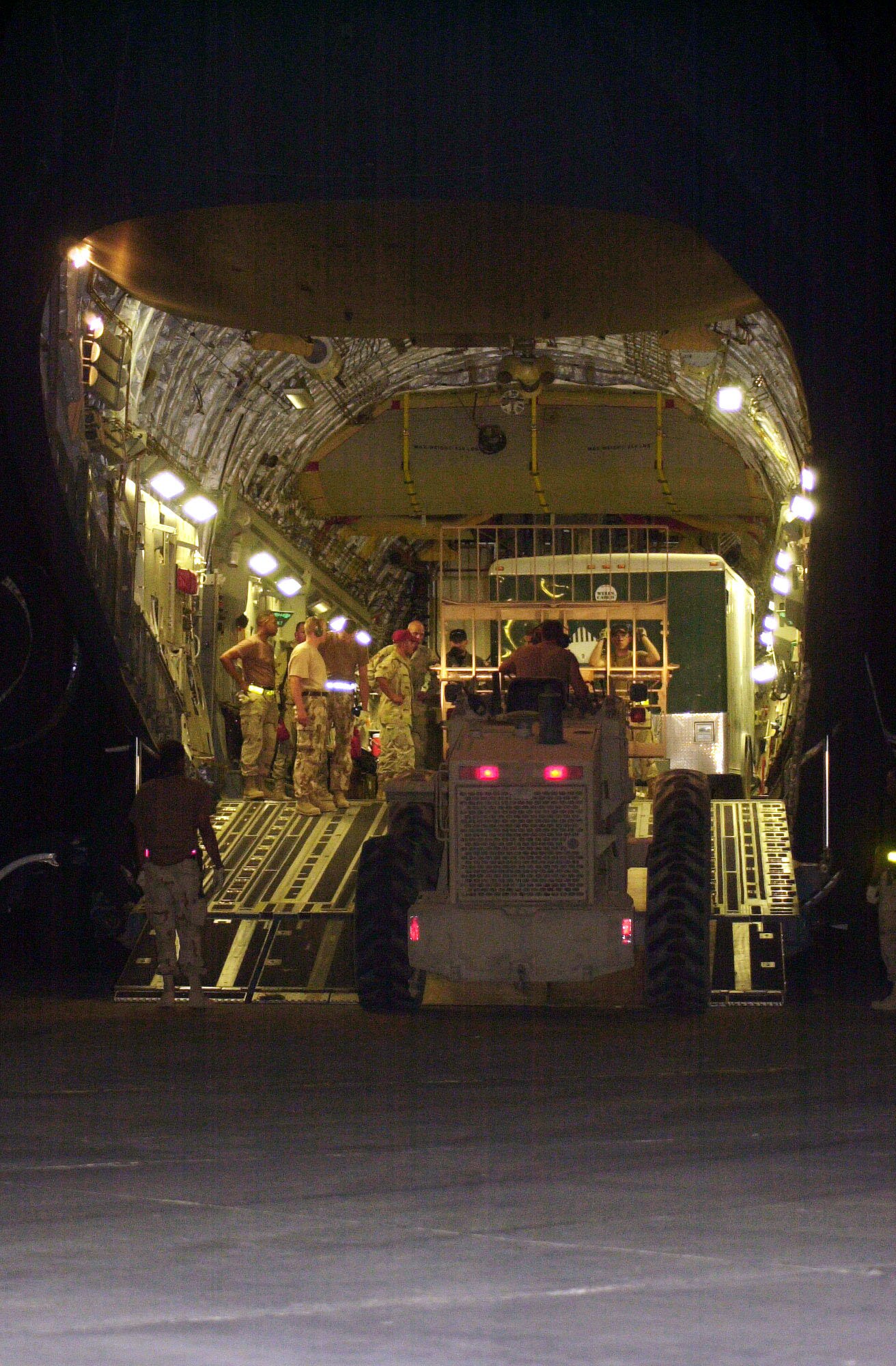 TALLIL AIR BASE, Iraq -- Airmen unload one of three planes of equipment and materials for the 1st Expeditionary Red Horse Group on June 26.  The engineering team will spend three weeks repairing the runways so heavy aircraft can land here.  (U.S. Air Force photo by Master Sgt. Deb Smith)