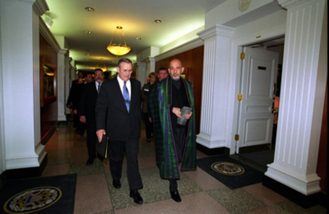 Secretary of Defense Donald H. Rumsfeld (left) escorts Afghan President Hamid Karzai as he departs the Pentagon on Feb. 27, 2003. Rumsfeld and Karzai met earlier to discuss defense issues of mutual interest and the future of Afghanistan, and then briefed reporters during a joint press conference. 
