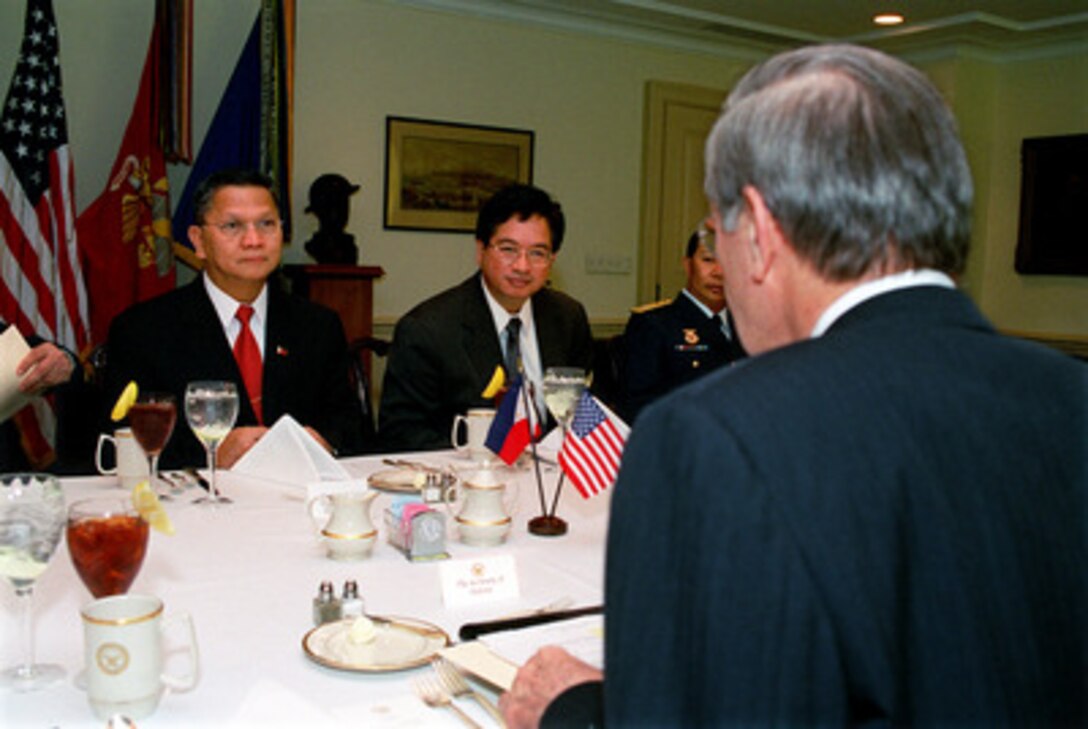 Philippine Secretary of National Defense Angelo Reyes (left) is the guest of honor at a working lunch hosted by Secretary of Defense Donald H. Rumsfeld in the Pentagon on Feb. 28, 2003. Reyes and Rumsfeld discussed a number of bilateral security concerns including the issue of how the United States could better help the Philippine government in its attempt to eliminate the terrorist organization Abu Sayyaf as part of the global war on terror. Philippine Assistant Secretary of Defense for Strategic Assessment and International Policy Alejandro Melchor (center) joined the talks. 