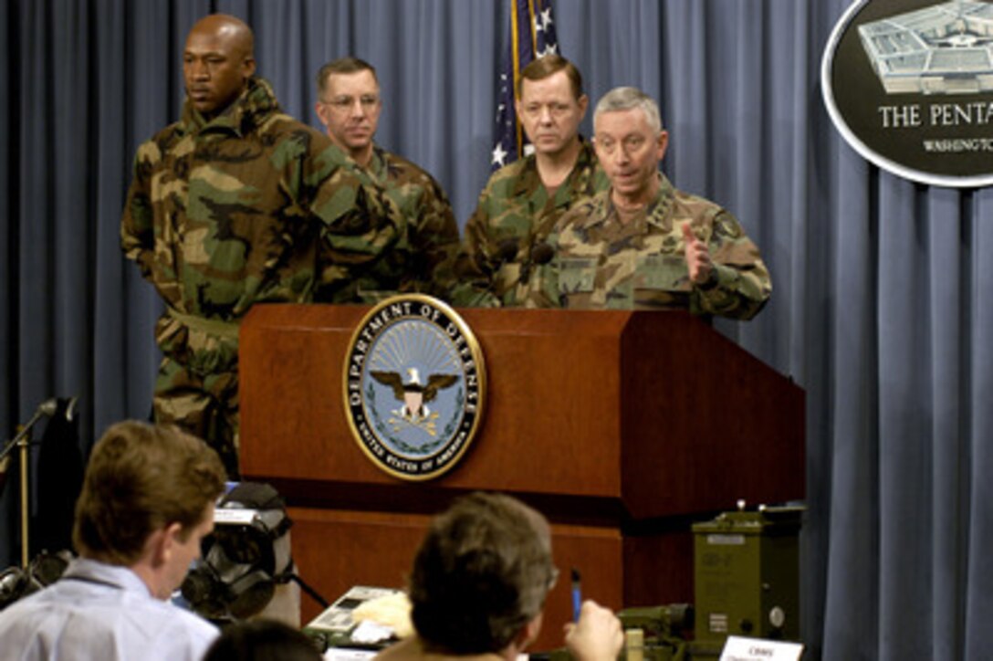 Army Maj. Gen. John Doesburg (right) briefs reporters on some of the protective gear and detection equipment being used by U.S. troops deployed for a possible war with Iraq during a March 3, 2003, Pentagon news briefing. The soldier at the left models the latest protective suit being issued to all deploying troops. Col. Thomas W. Spoehr (2nd from left), commander of the 3rd Chemical Brigade, U.S. Army Chemical School and Brig. Gen. Stephen Reeves, program executive officer for chemical and biological defense for the Department of Defense joined Doesburg for the briefing. Doesburg is the commander of the Soldier Biological and Chemical Defense Command. 