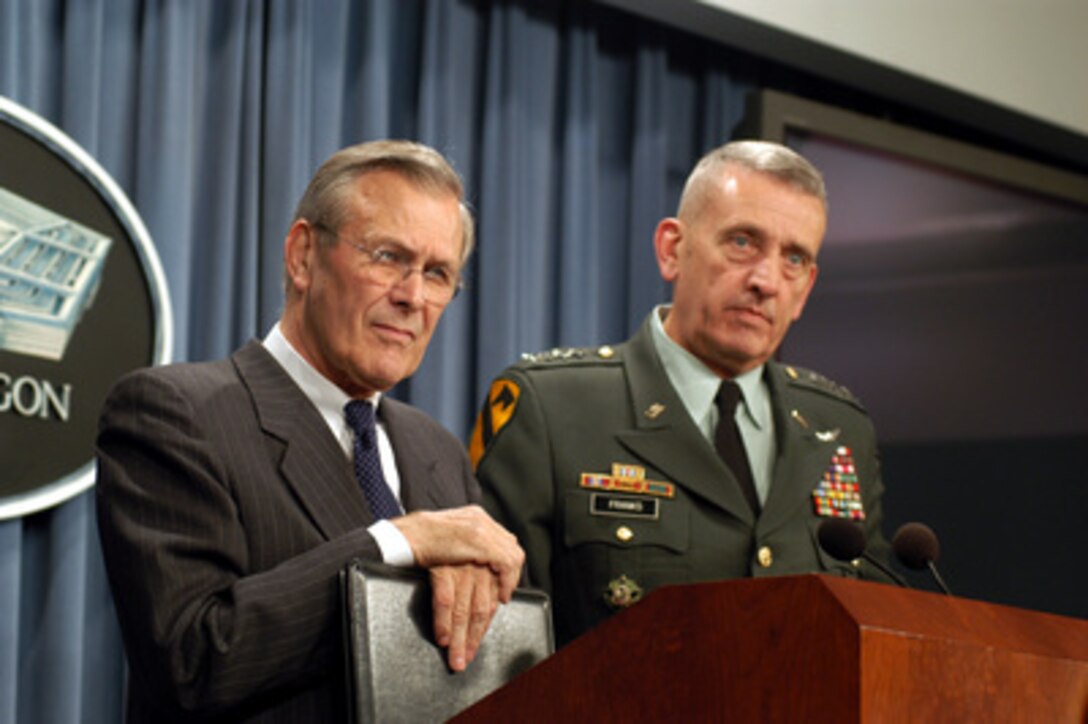 Secretary of Defense Donald H. Rumsfeld (left) and Commander, Central Command Gen. Tommy Franks, U.S. Army, listen to a question at the close of a Pentagon press conference on March 5, 2003. Rumsfeld and Franks gave reporters an operational update and fielded questions on the possible conflict in Iraq. 