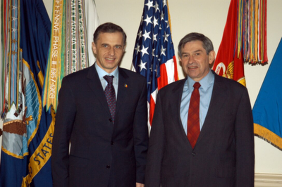 Romanian Minister of Foreign Affairs Mircea Dan Geoana (left) and Deputy Secretary of Defense Paul Wolfowitz pose for photographs prior to their meeting in the Pentagon on Feb. 7, 2003. 