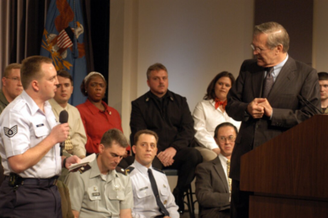 Secretary of Defense Donald H. Rumsfeld listens to a question from Air Force Staff Sgt. Benjamin Schleis at a town hall meeting in the Pentagon auditorium on March 6, 2003. Rumsfeld delivered opening remarks then fielded questions from military and civilian Pentagon employees. The forum allows people in the Pentagon to direct their questions to the top man at the Defense Department. 